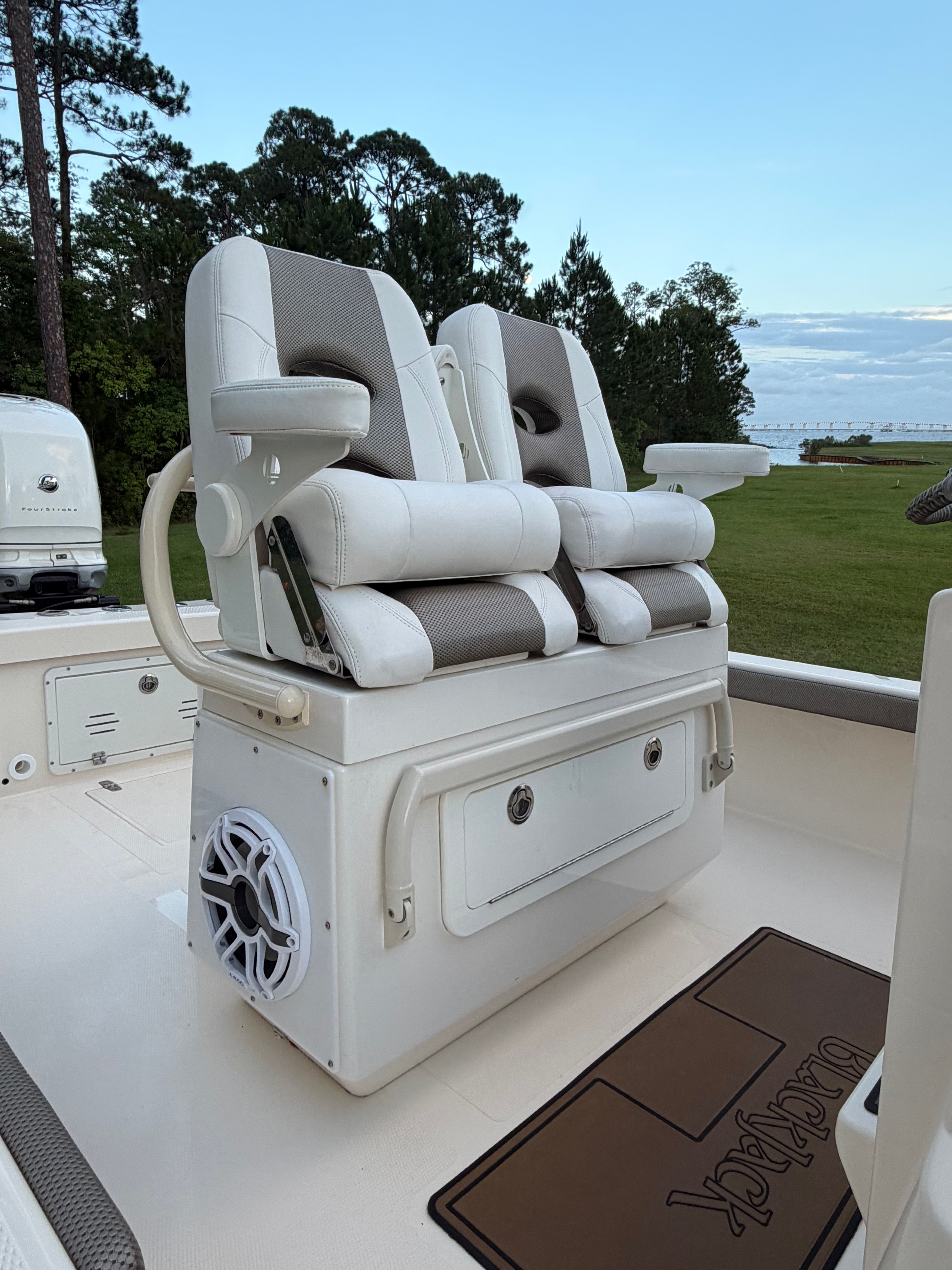 2022 BlackJack 256 Coastal boat with luxurious seating and speaker.