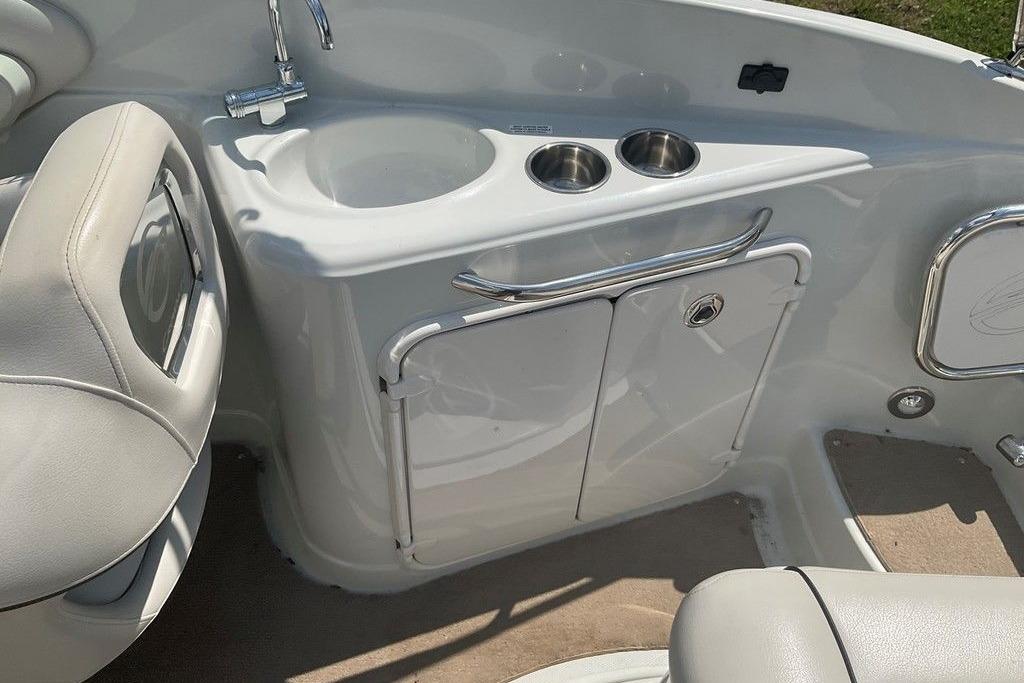 2015 Crownline 236 SC boat interior with sink and cup holders.
