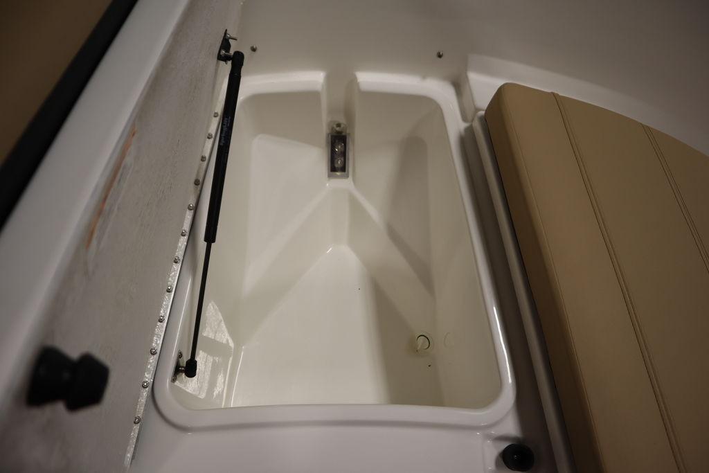 2026 Bayliner Trophy T20CC storage compartment with cushioned seating.