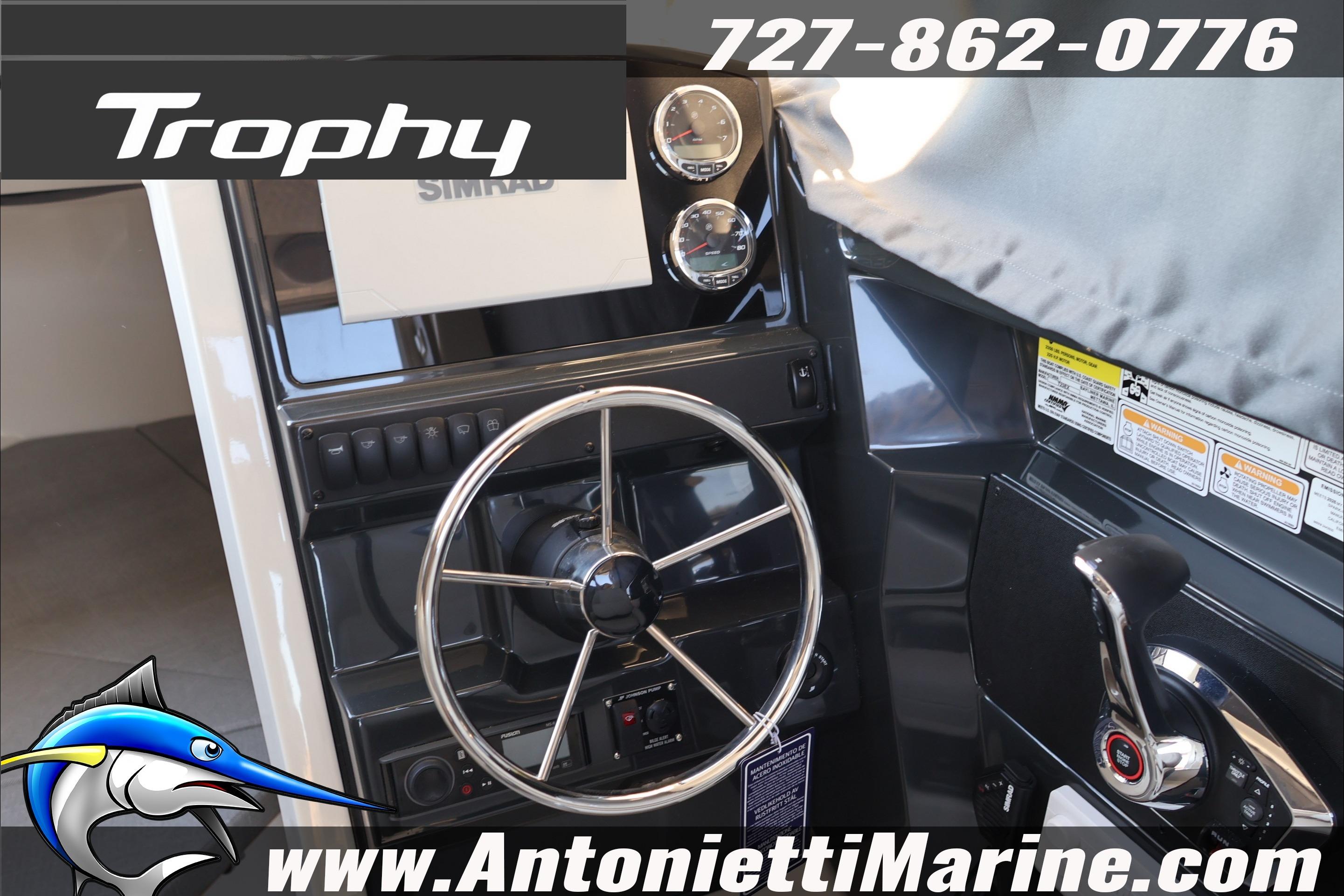2026 Bayliner Trophy T23 Explorer helm with steering wheel and controls, featuring Simrad electronics.