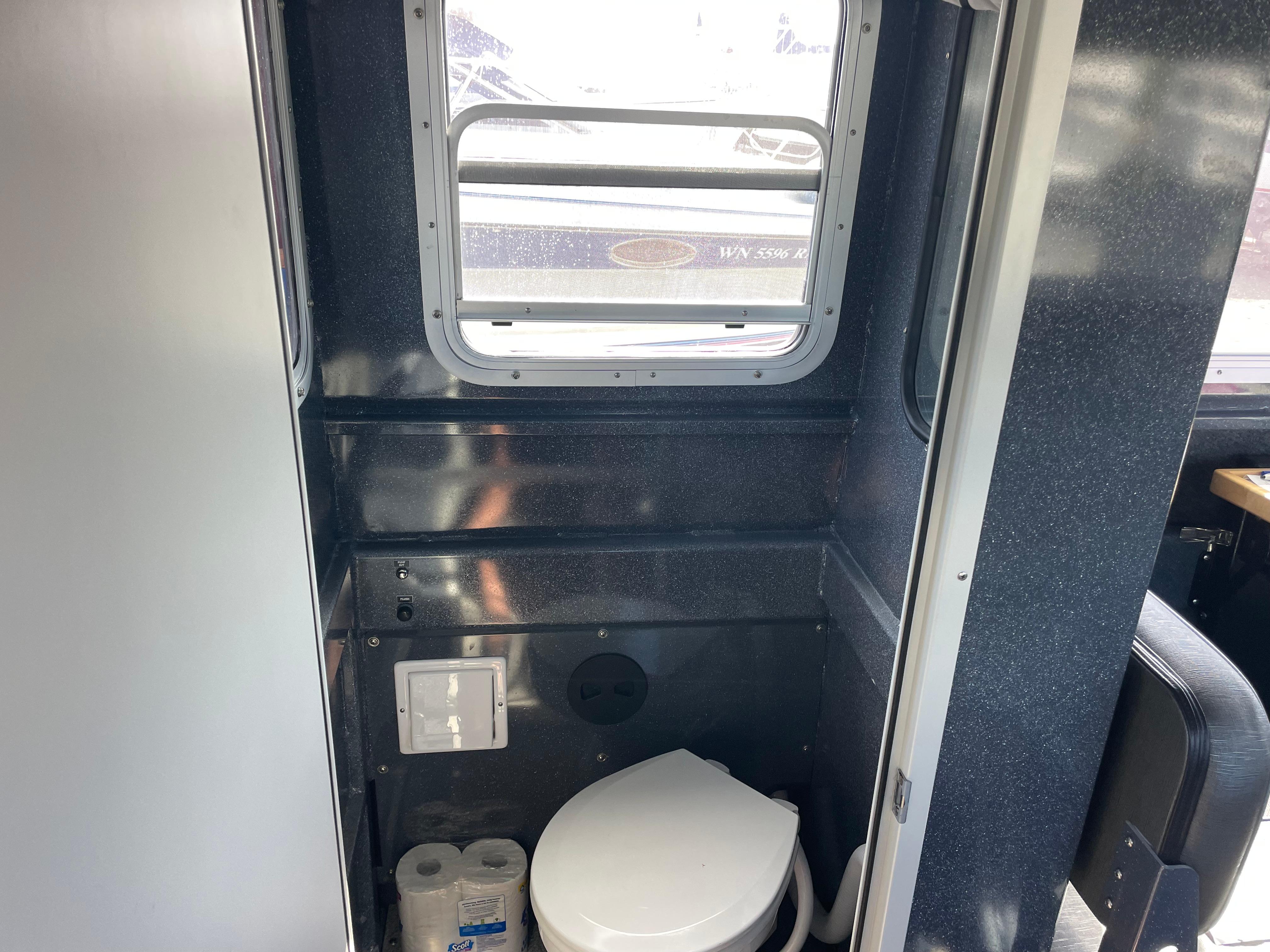 2018 Duckworth 28 Offshore boat interior with compact bathroom and window.