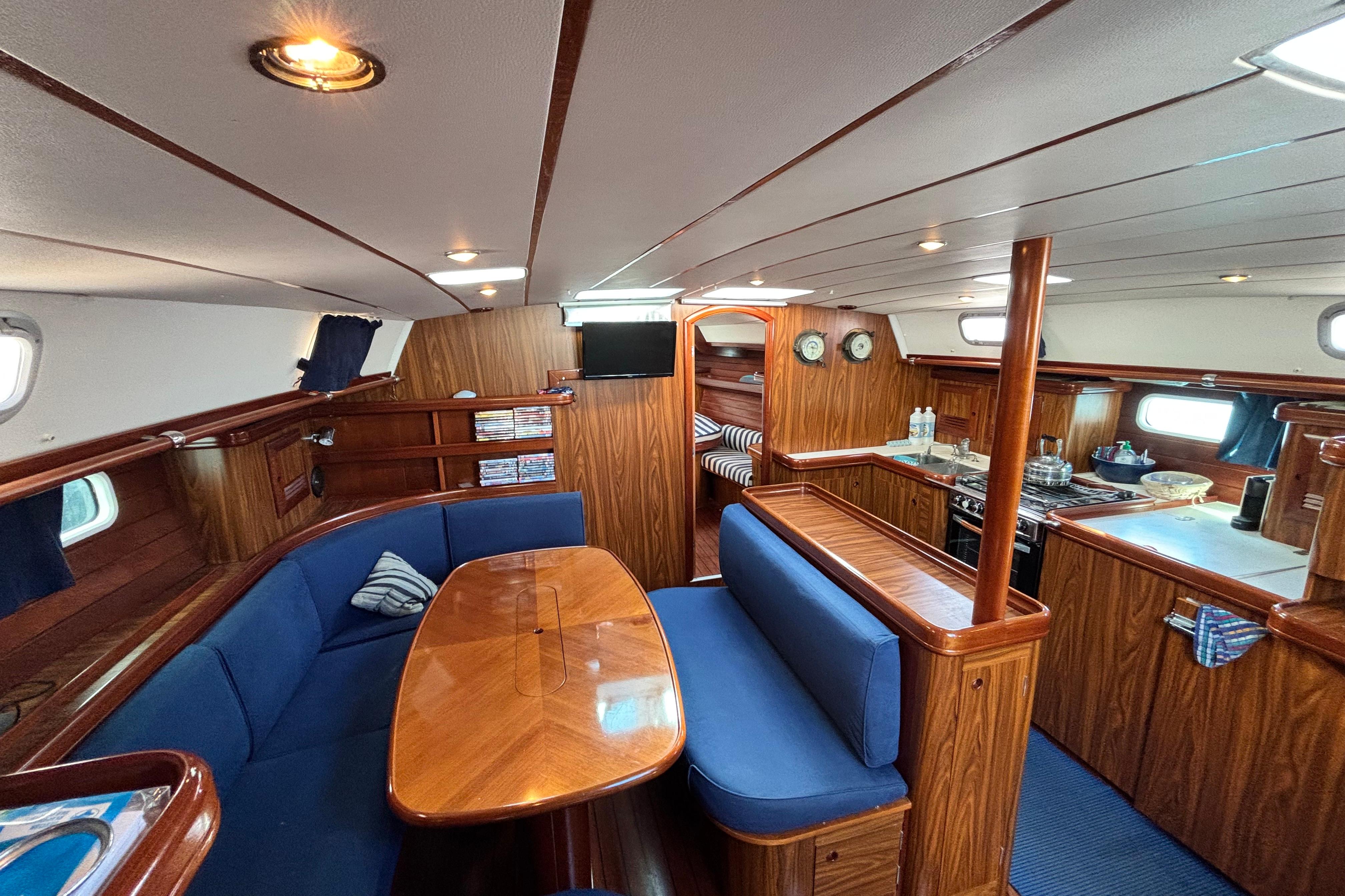Luxurious 2005 Beneteau 50 yacht interior with elegant wood finish and cozy seating area.