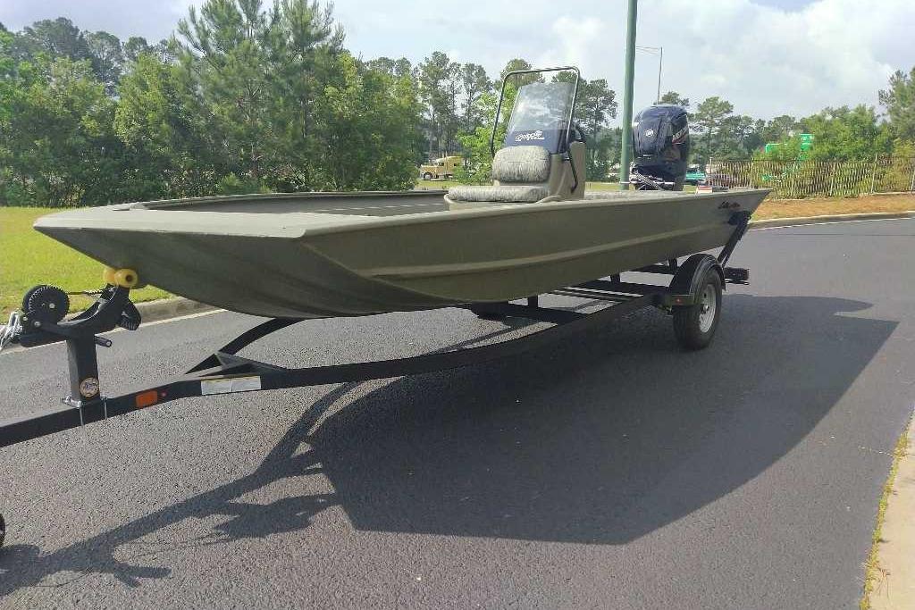 2026 Tracker Grizzly 1860 CC boat on trailer, parked on a paved road.