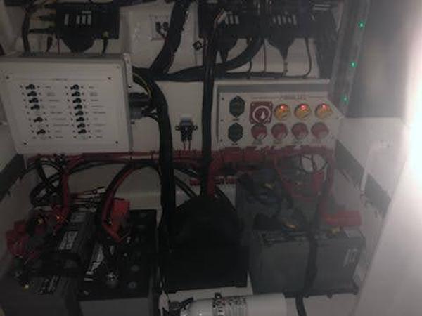 Electrical system of a 2019 Midnight Express 39 Cuddy boat, featuring batteries and control panels.