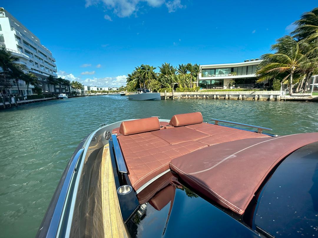 2019 SACS Rebel 40 yacht cruising in a sunny, tropical canal setting.