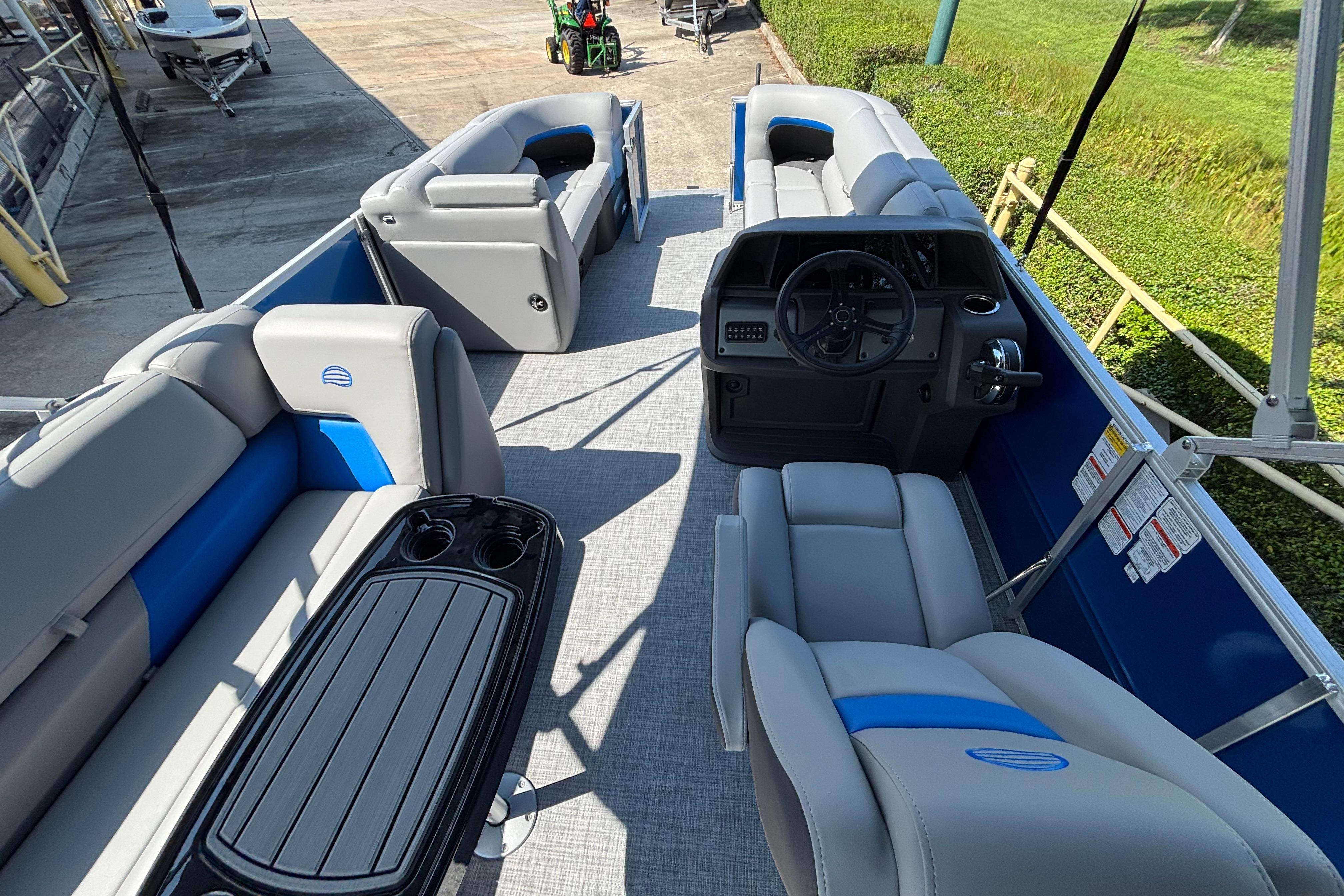 2026 Sun Tracker Party Barge 20 DLX interior with seating and steering console.