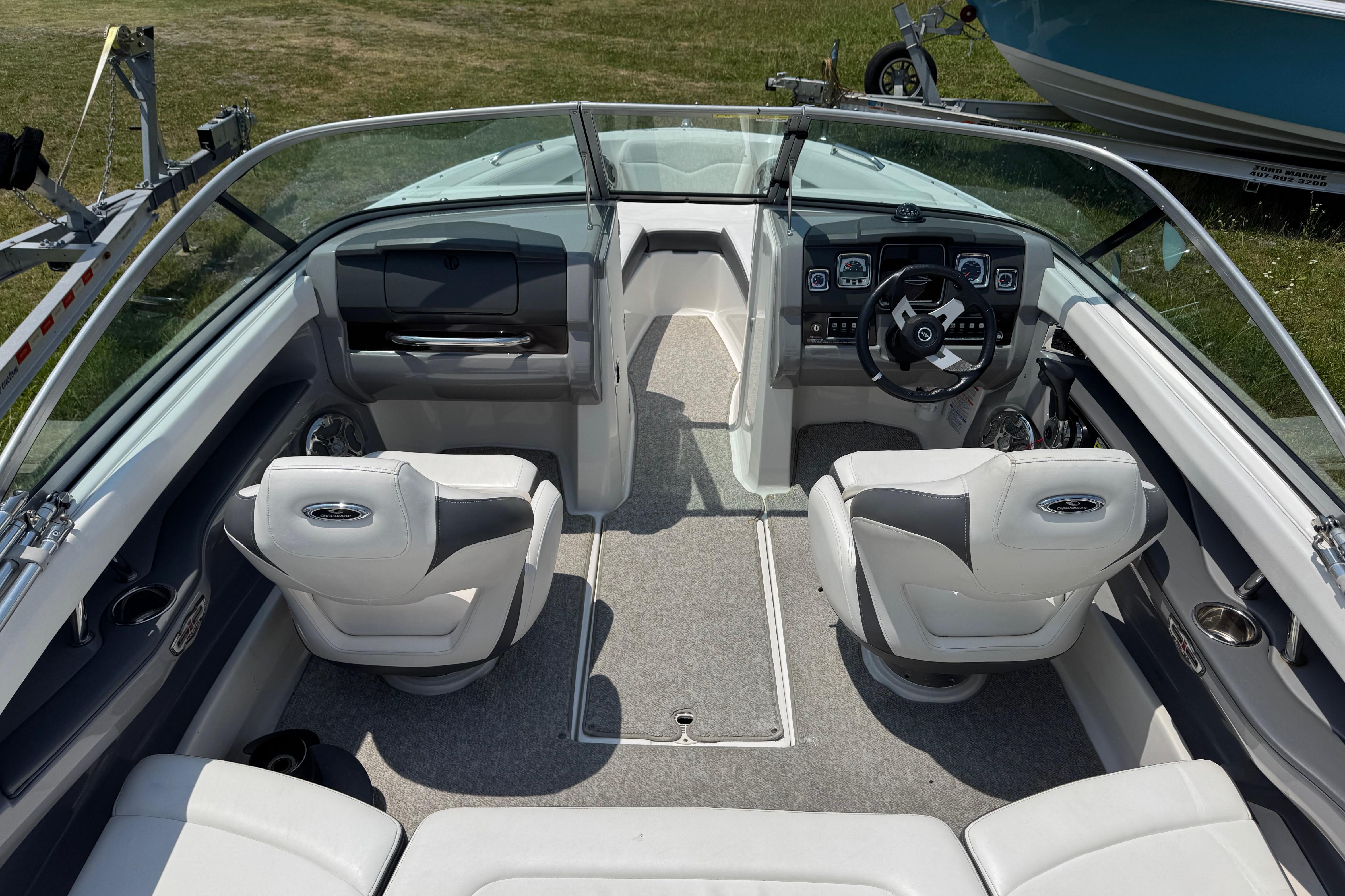 2013 Chaparral 196 SSi boat interior with white seating and modern dashboard.
