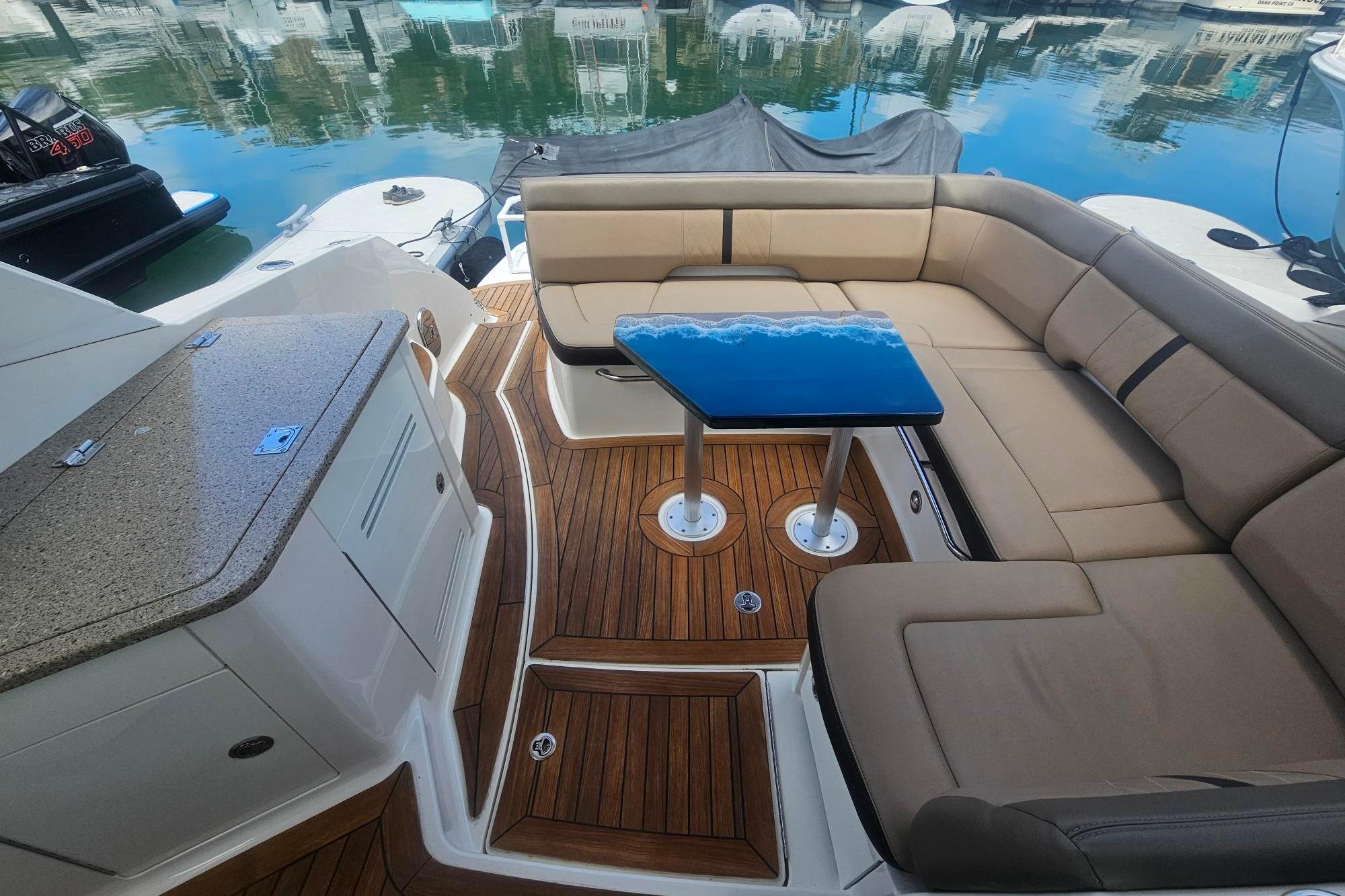 Luxurious 2016 Sea Ray Sundancer 350 yacht interior with elegant seating and sleek table design.