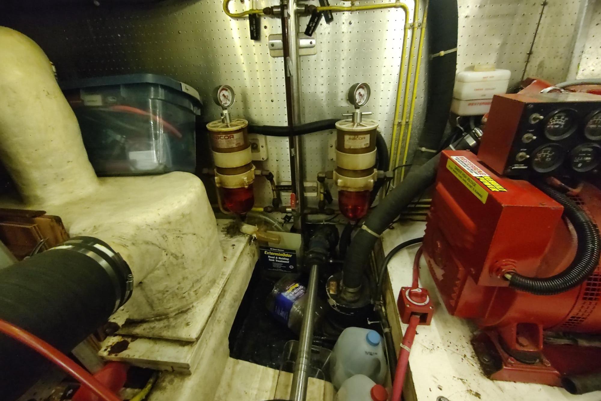 Engine room of a 1989 Hyatt Double Cabin Motoryacht with mechanical components and gauges.