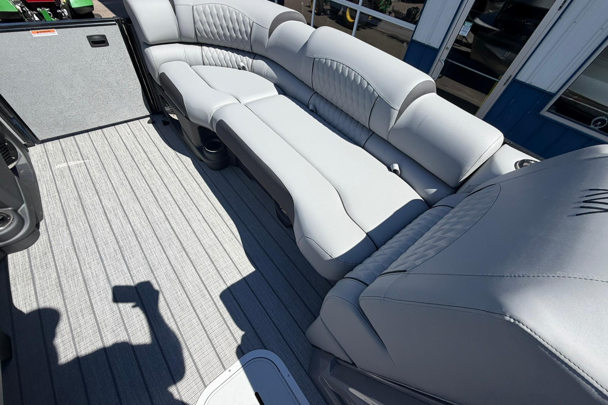 Luxurious seating on 2026 Avalon Catalina Quad Lounge Shift boat, featuring sleek gray upholstery.