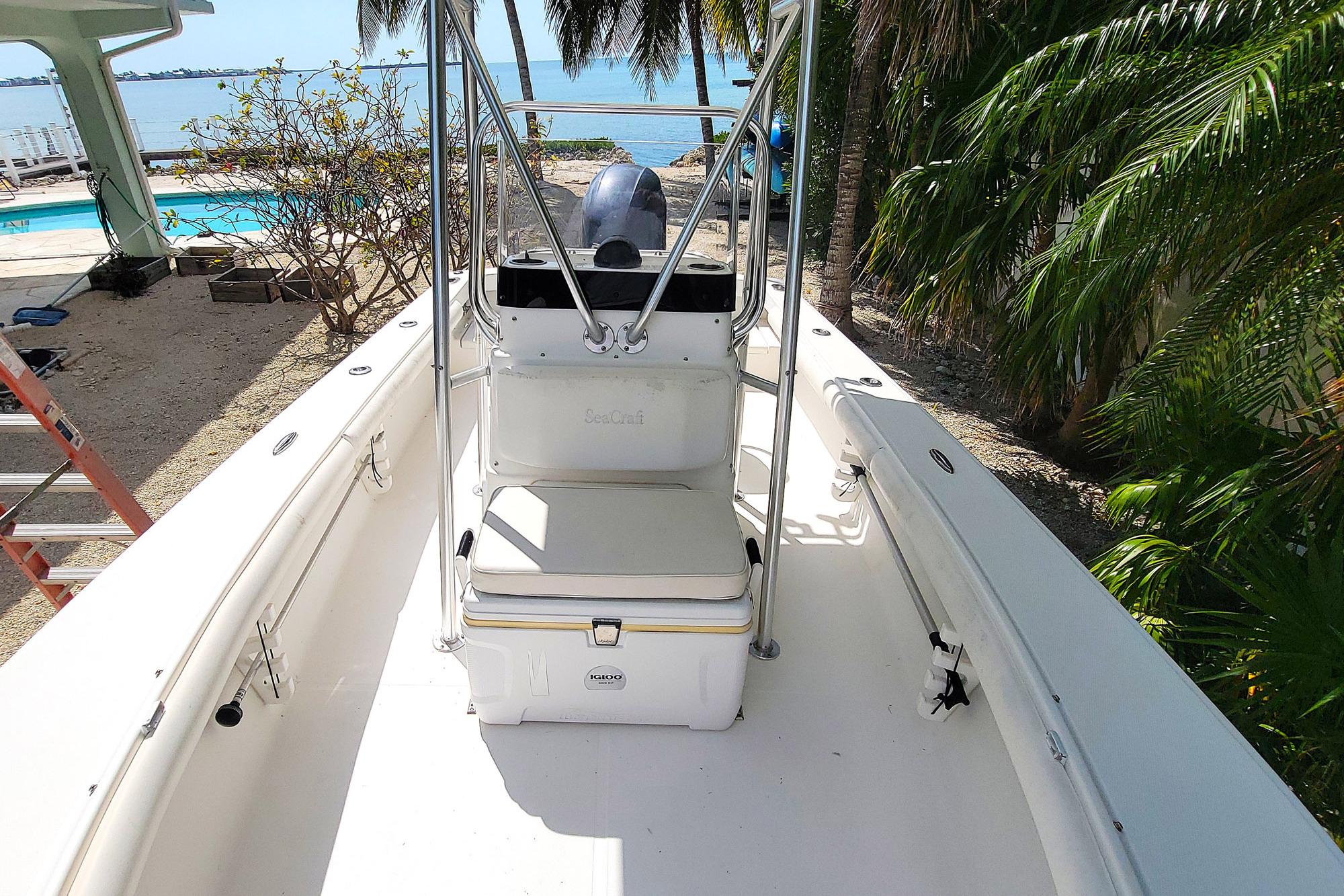 2008 SeaCraft SC 20 Classic boat docked near tropical foliage and waterfront.