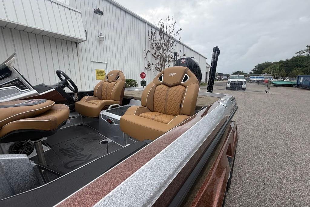 2026 Ranger Z520R boat with luxurious tan seating, parked outdoors near a white building.
