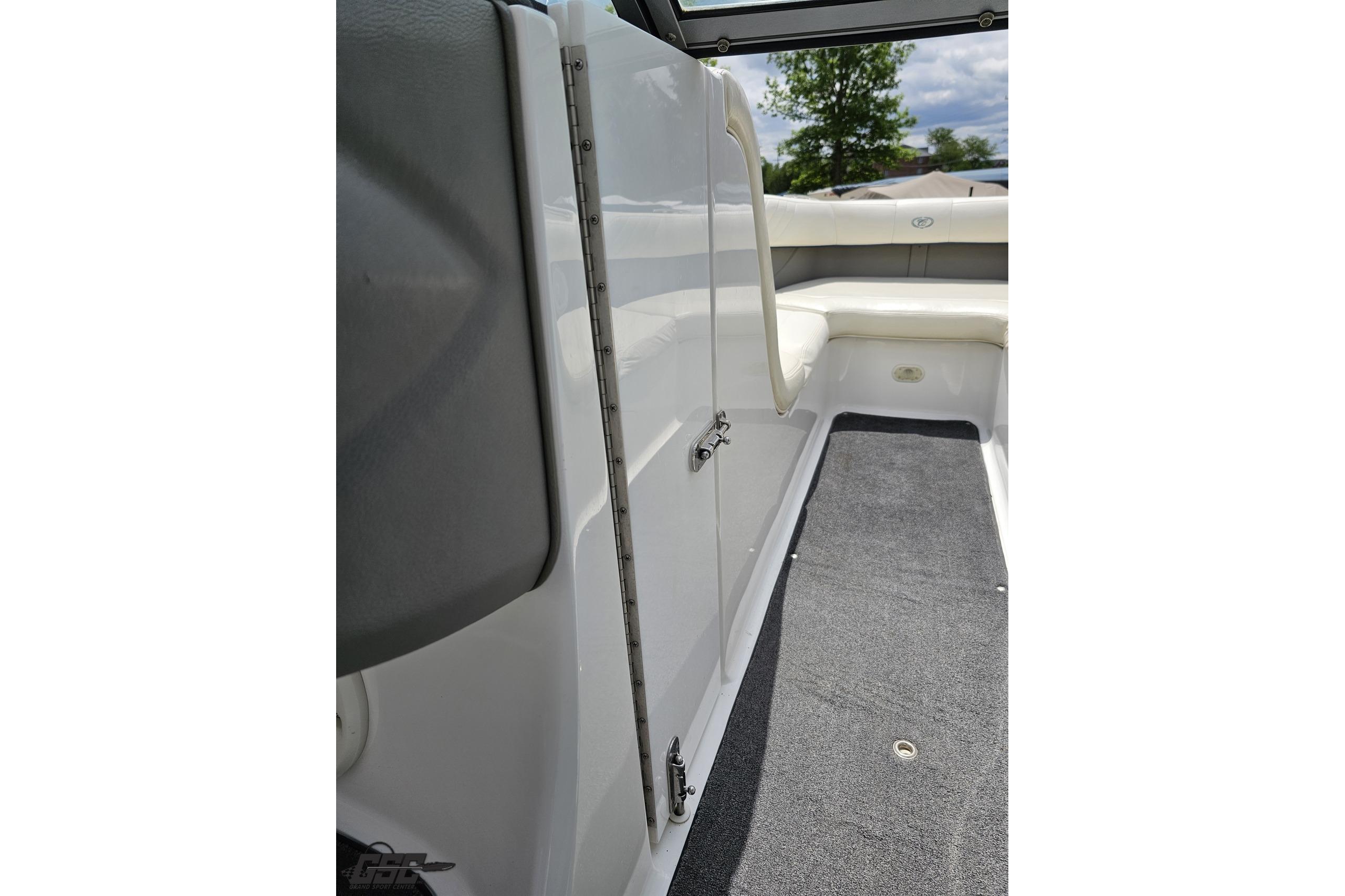 2010 Cobalt 232 WSS boat interior with white seating and gray carpet.