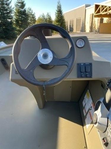 2024 Tracker Grizzly 1754 SC boat steering console with control panel and gauge.