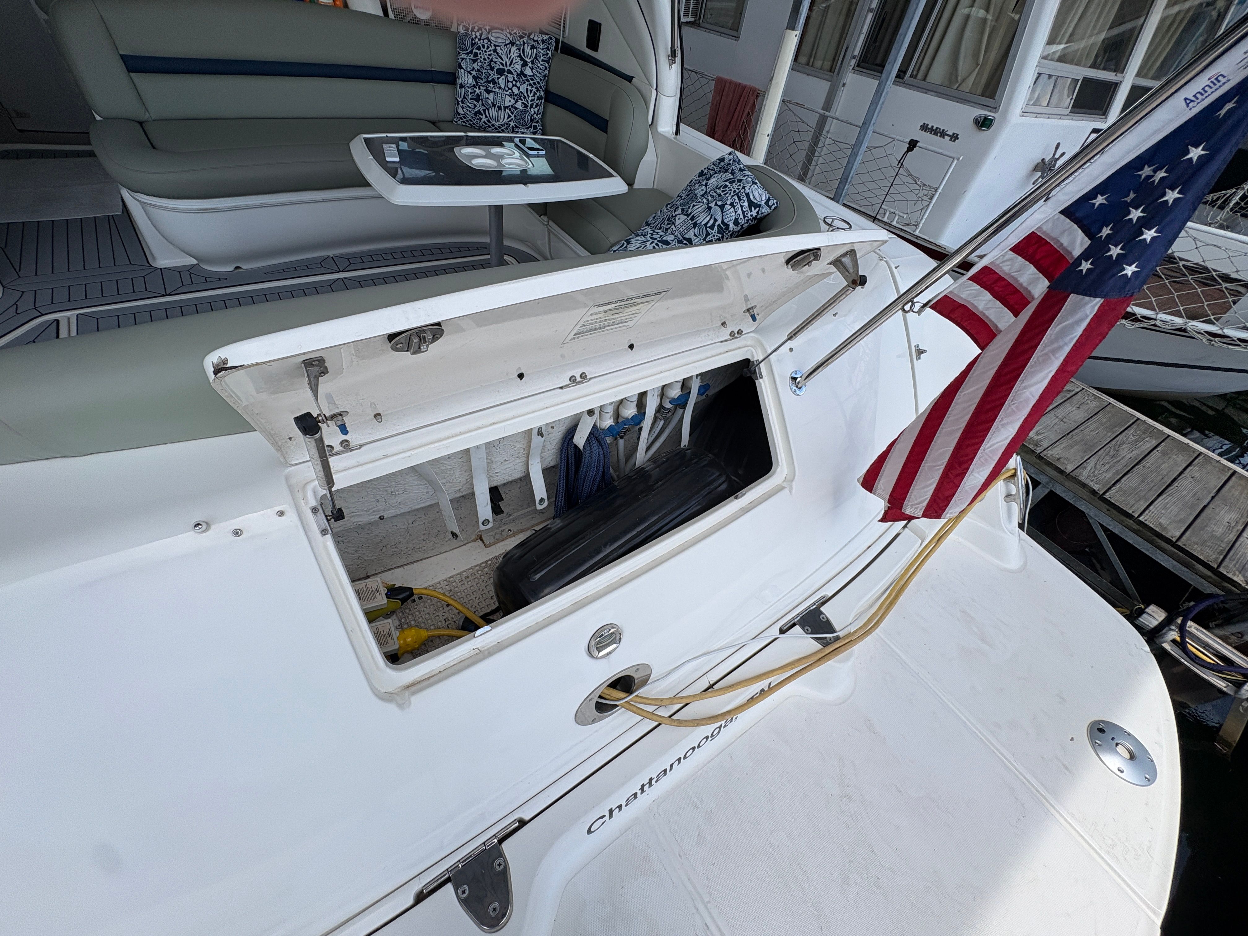 2005 Sea Ray 420 Sundancer with open storage hatch and US flag.