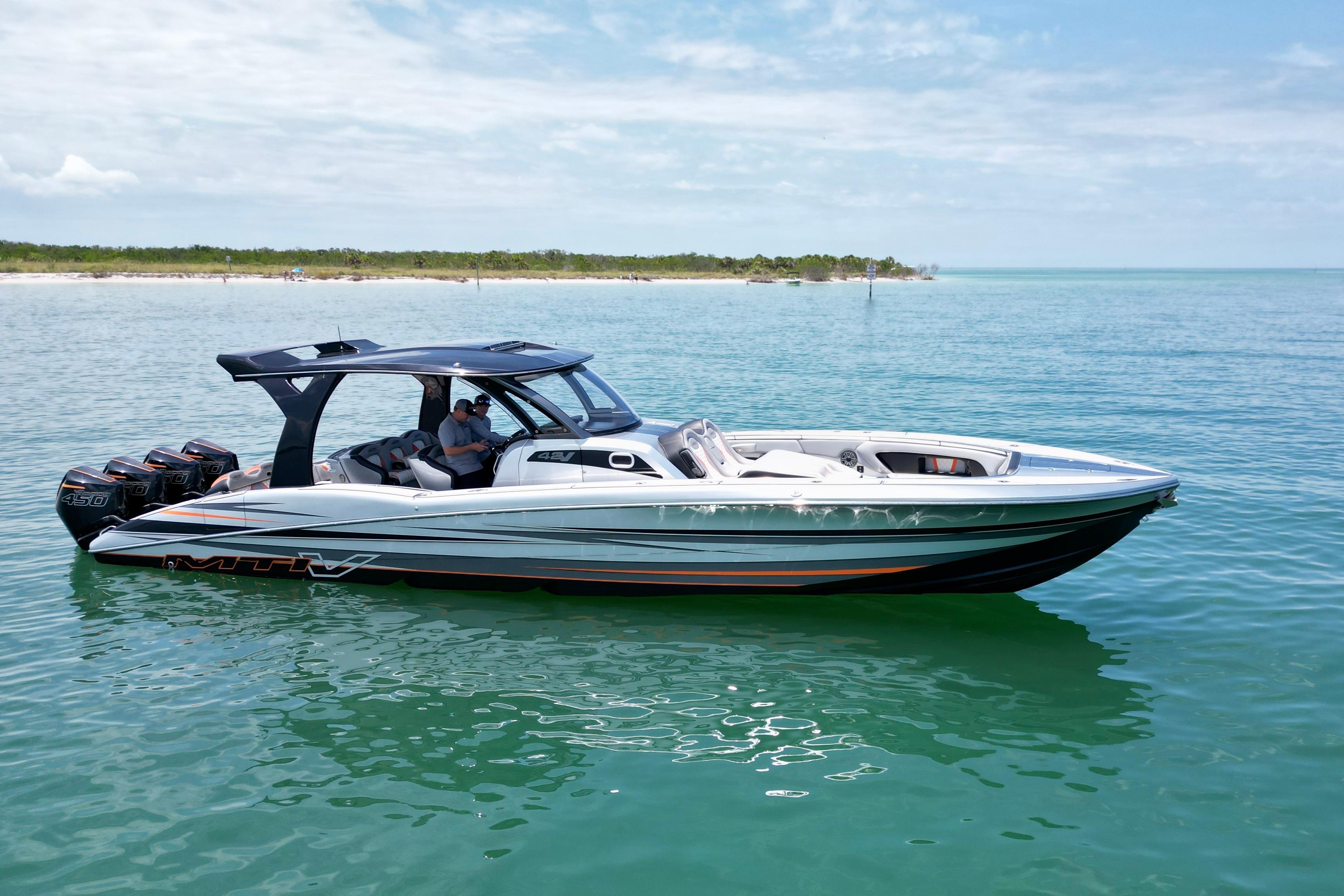 2017 MTI V42 boat on calm water, featuring sleek design and multiple outboard engines.
