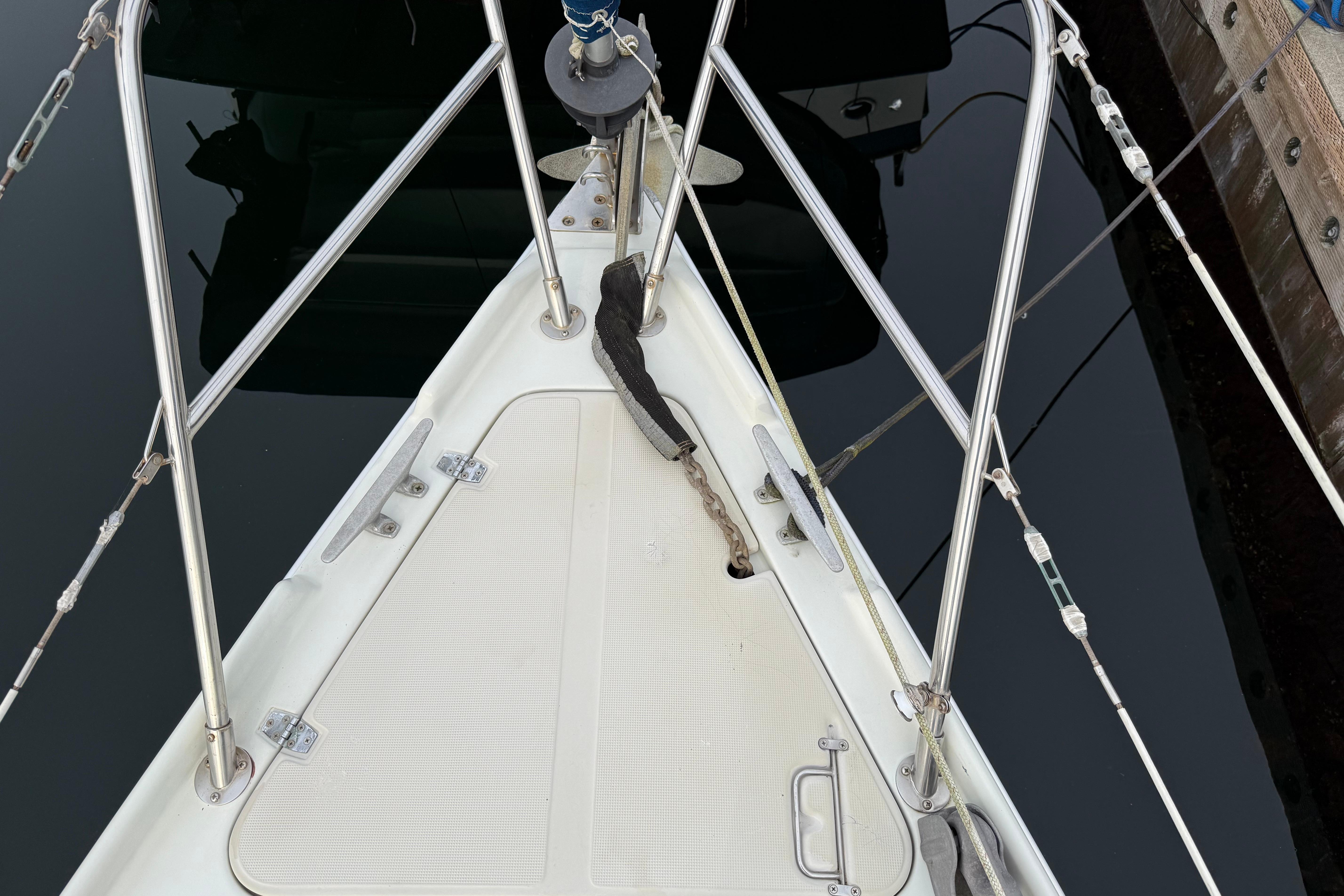 Bow of a 1988 Ericson 32-200 sailboat with stainless steel fittings and anchor chain.