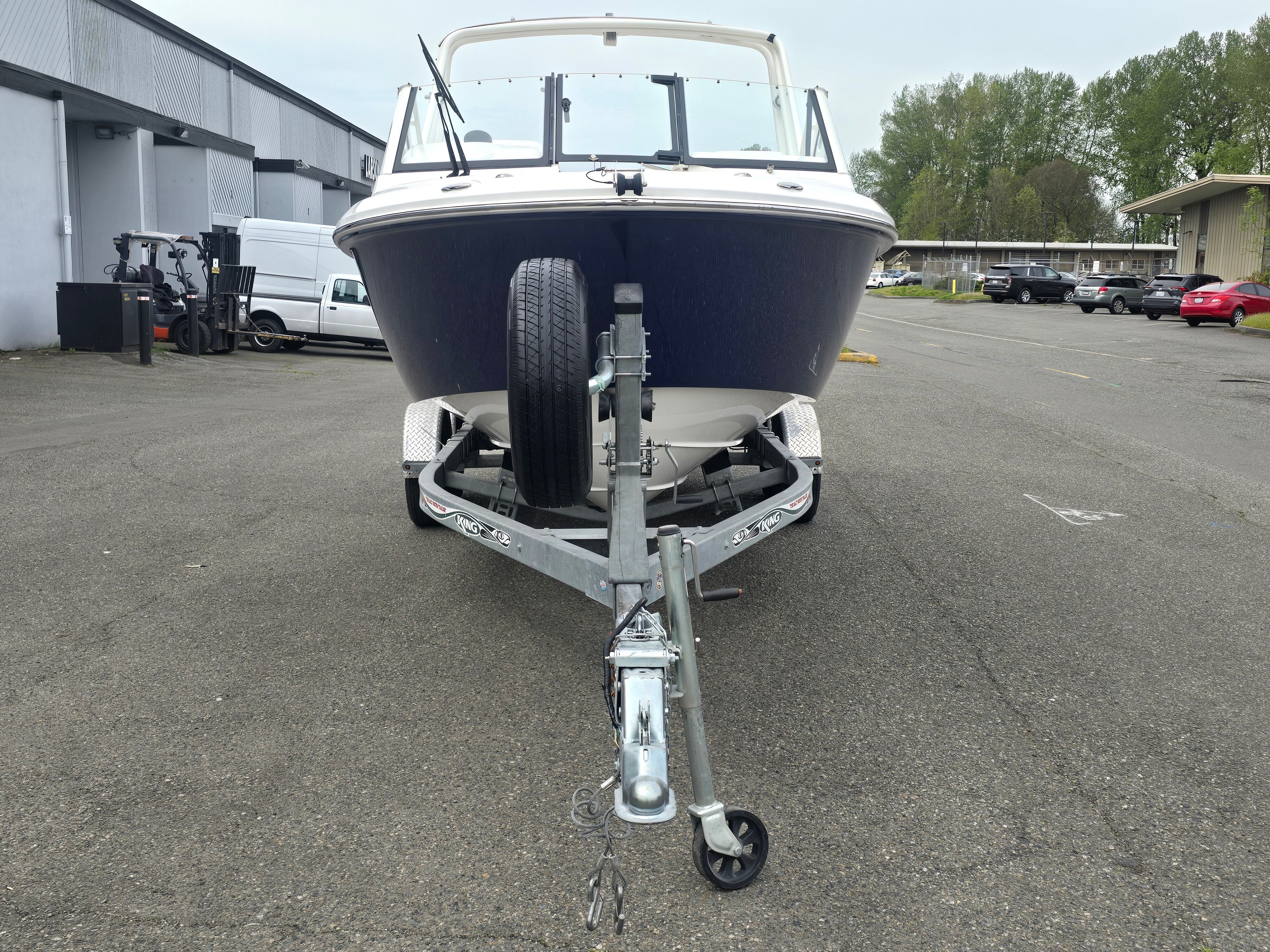 2017 Everglades 230 Dual Console on a trailer, parked on a paved lot.