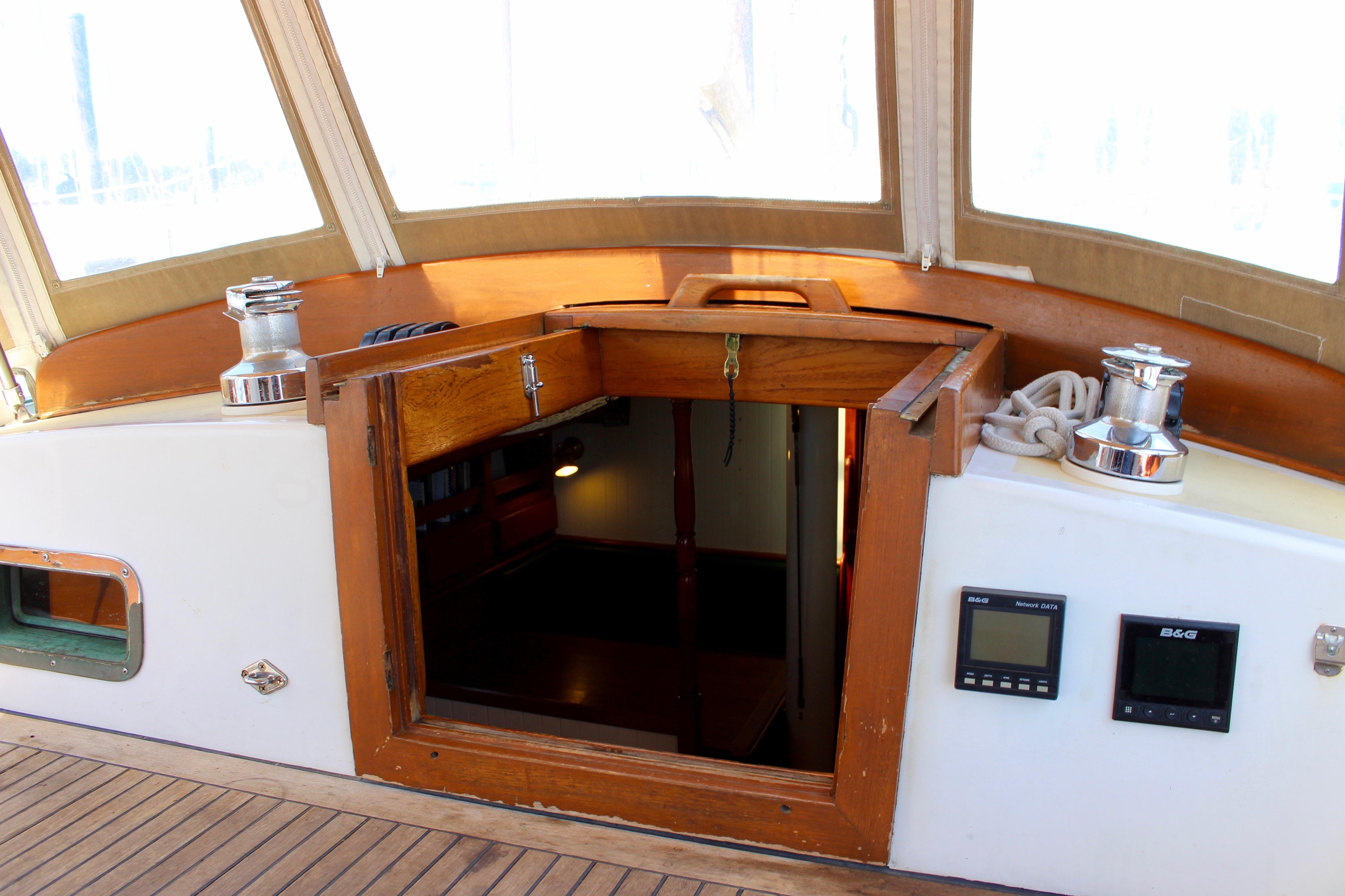 Cockpit of 1981 Kelly Peterson 46 sailboat with open hatch and navigation instruments.