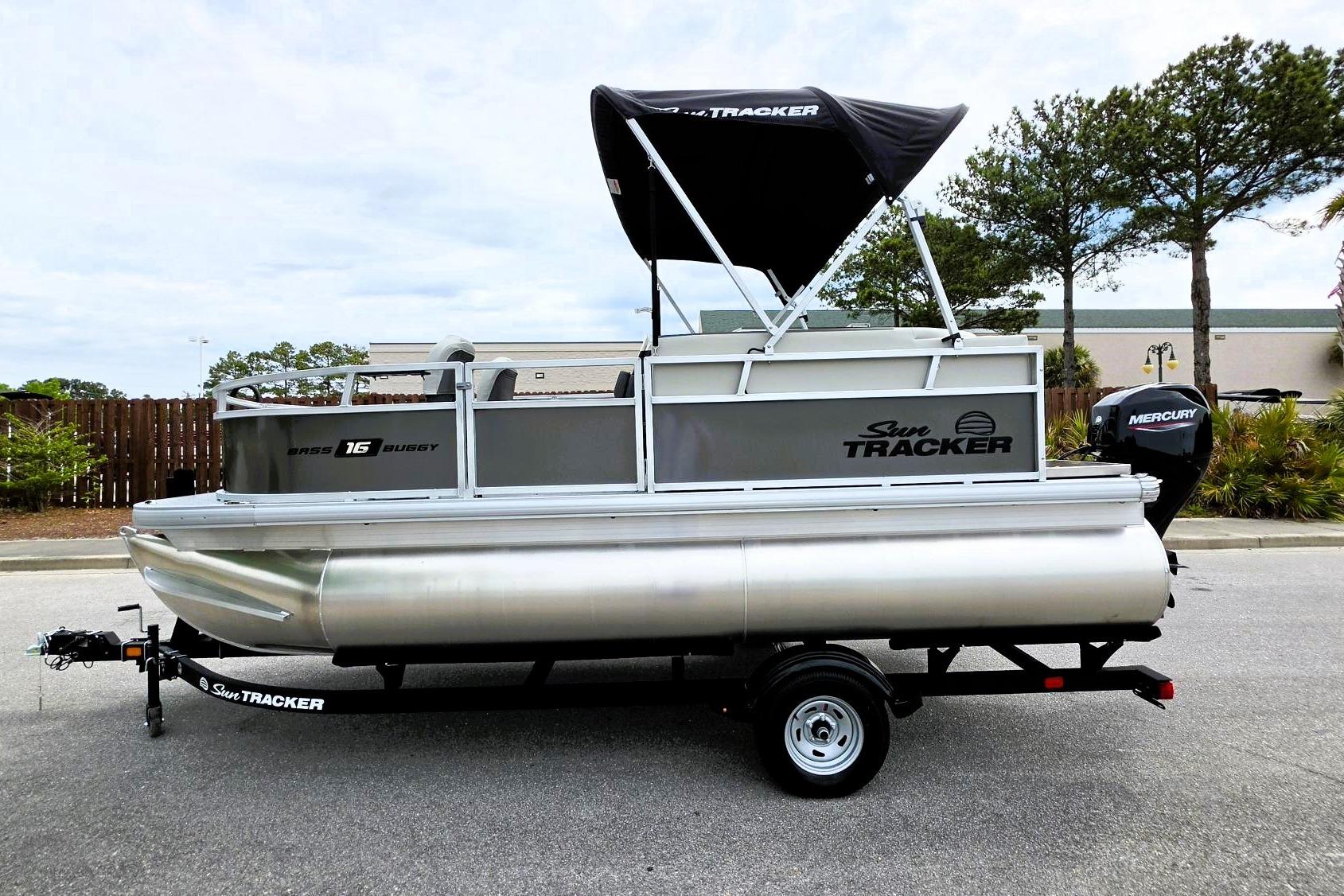 2026 Sun Tracker Bass Buggy 16 XL Select pontoon boat with Mercury engine on trailer.