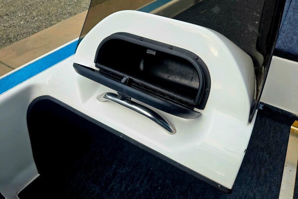 1996 Champion 181 SX boat interior with open storage compartment.