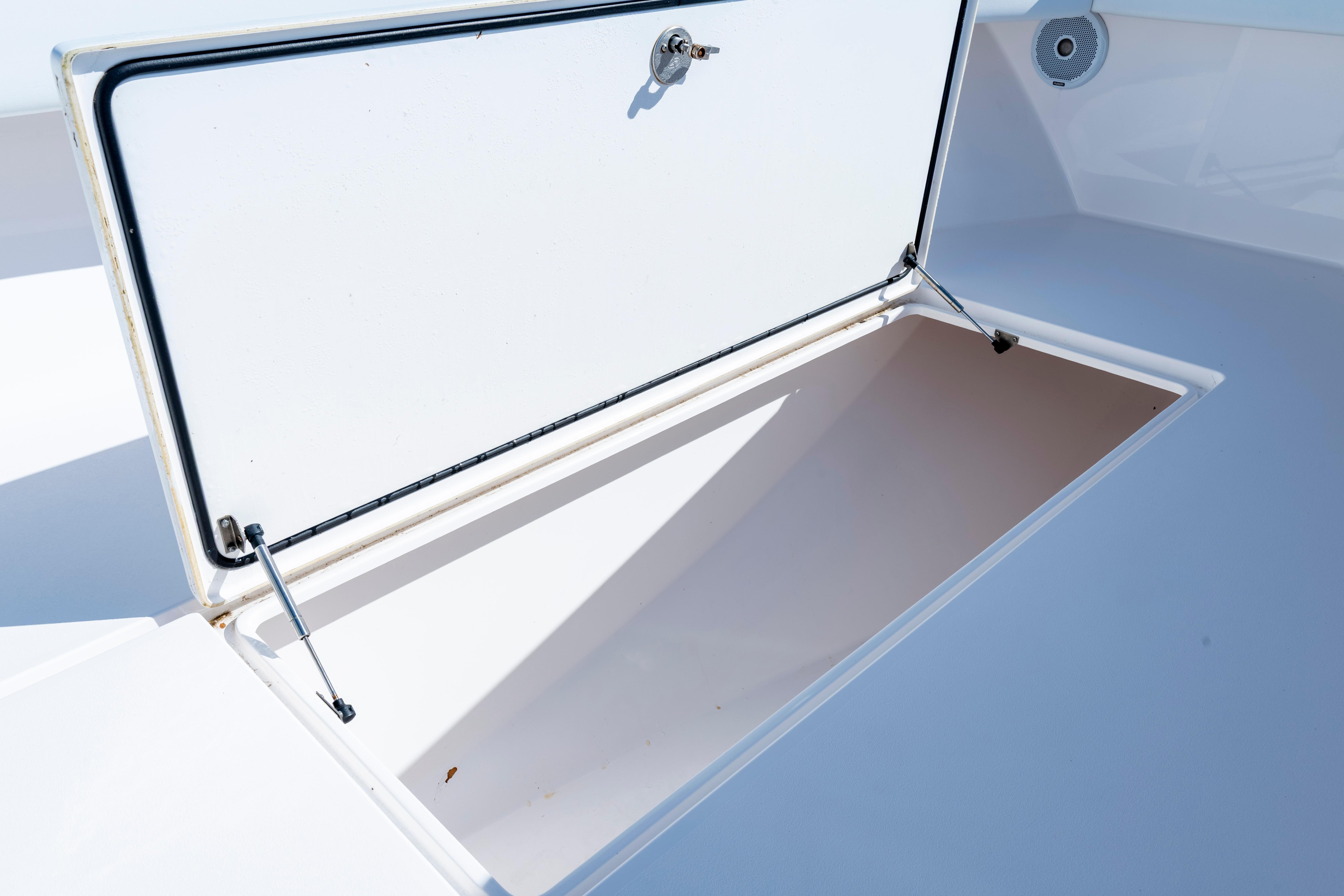 Open storage compartment on a 2015 Contender 39 ST boat, showcasing interior space.