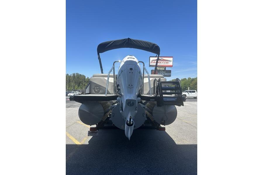 2026 Evotti 523QL boat with outboard motor, parked outdoors under clear blue sky.