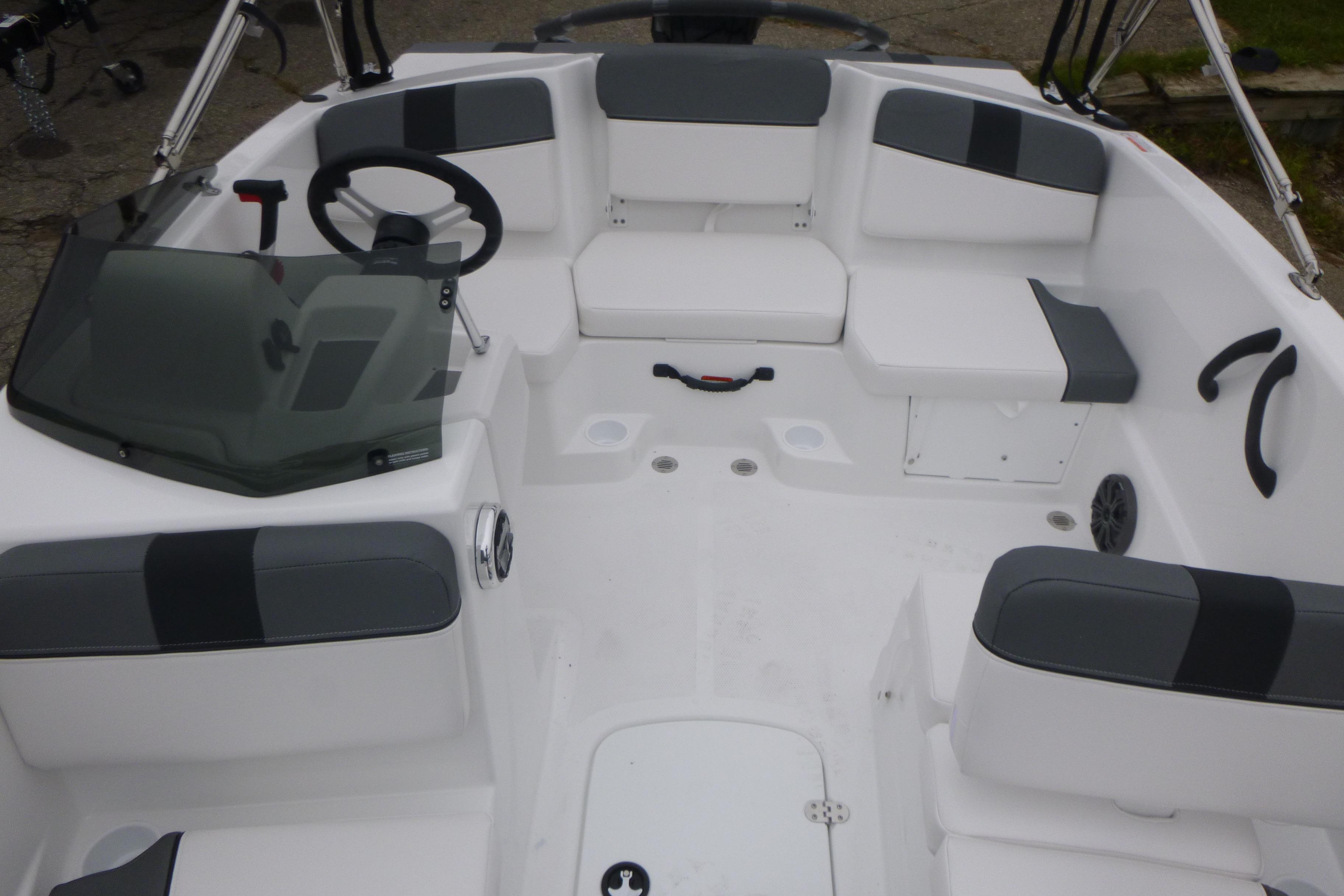 2026 Tahoe T16 boat interior with gray and white seating, steering wheel, and windshield.