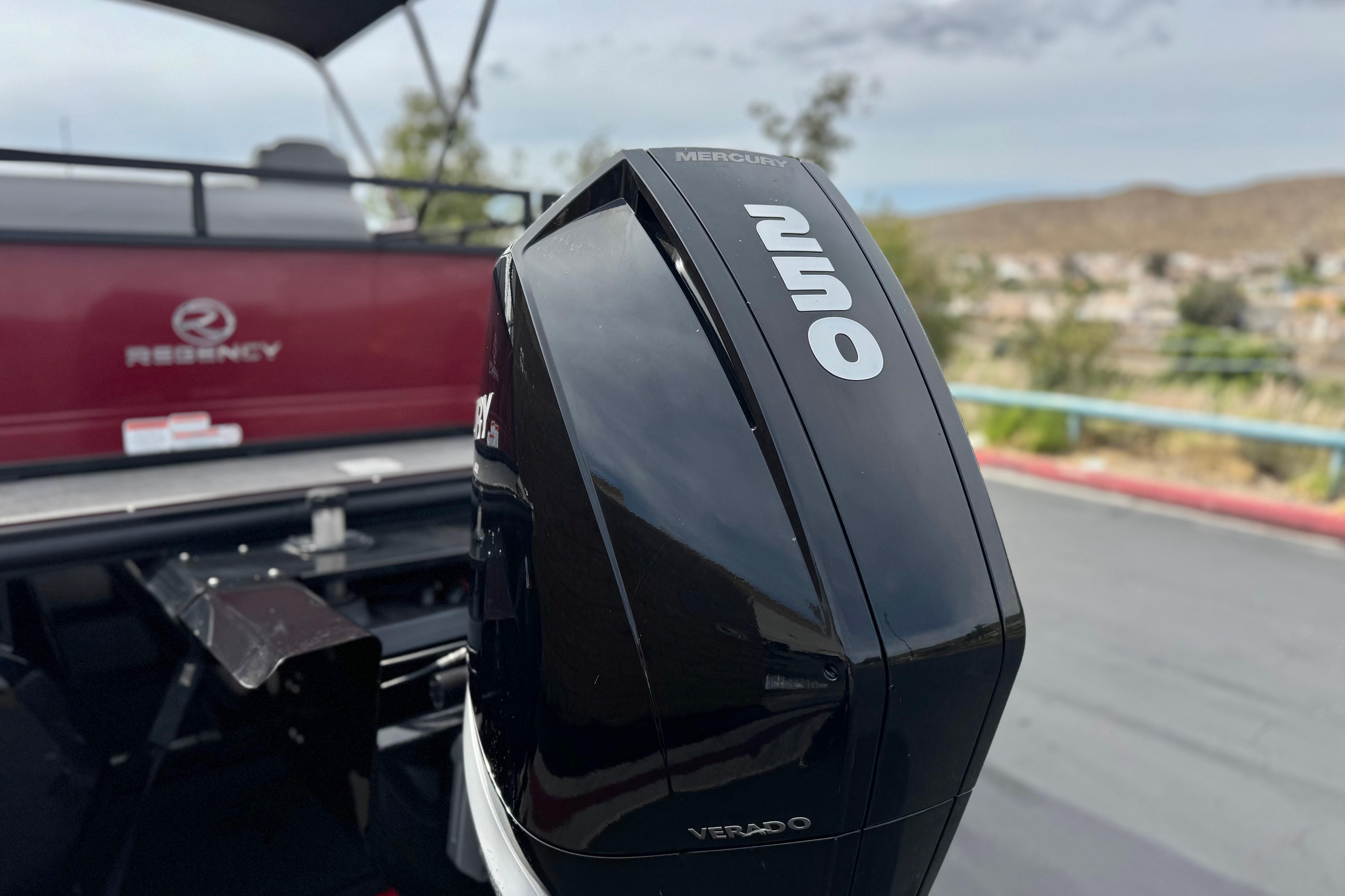 2022 Regency 250 DL3 boat with Mercury 250 Verado engine, outdoor setting.