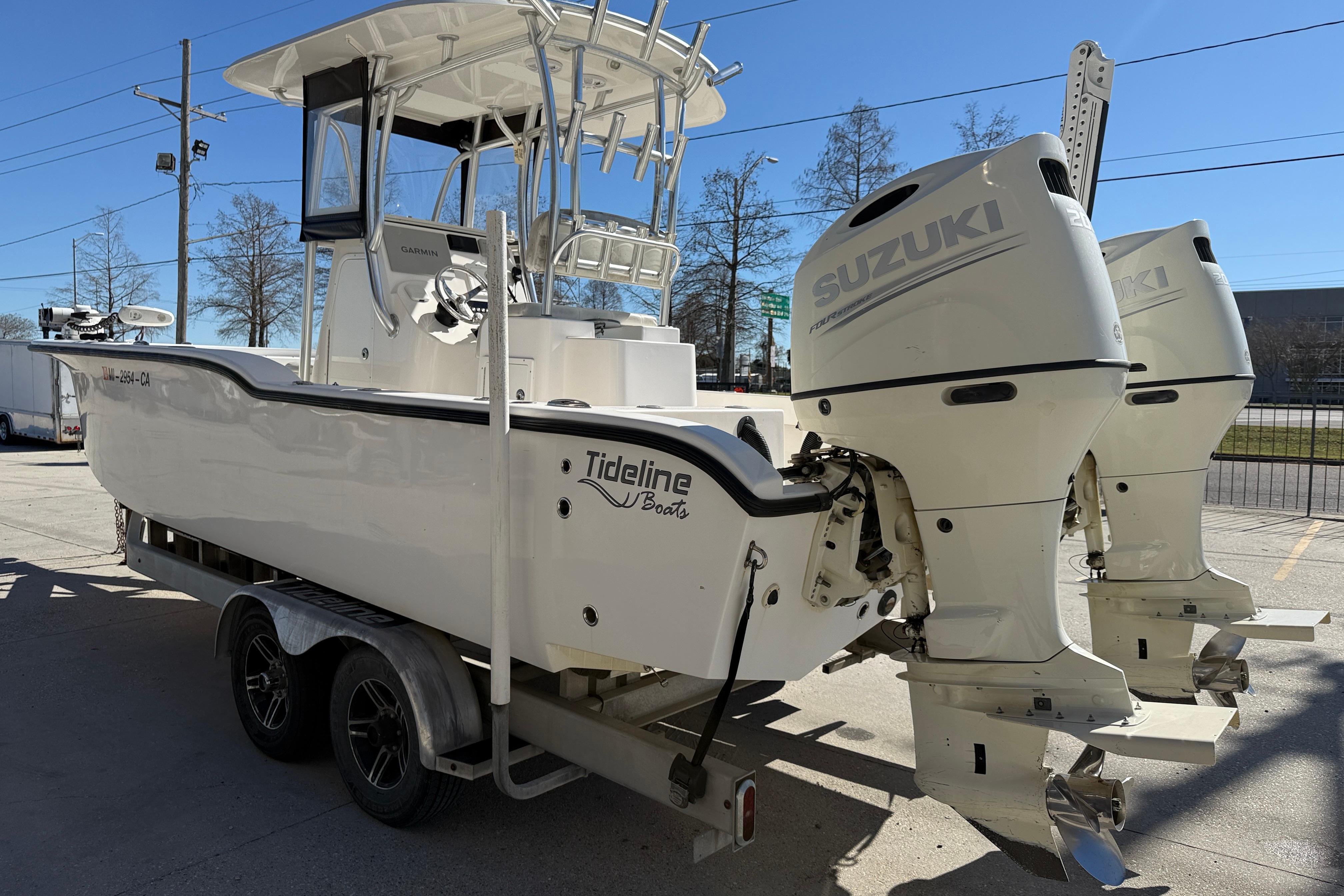 2020 Tideline 235 Hybrid boat with dual Suzuki engines on a trailer.