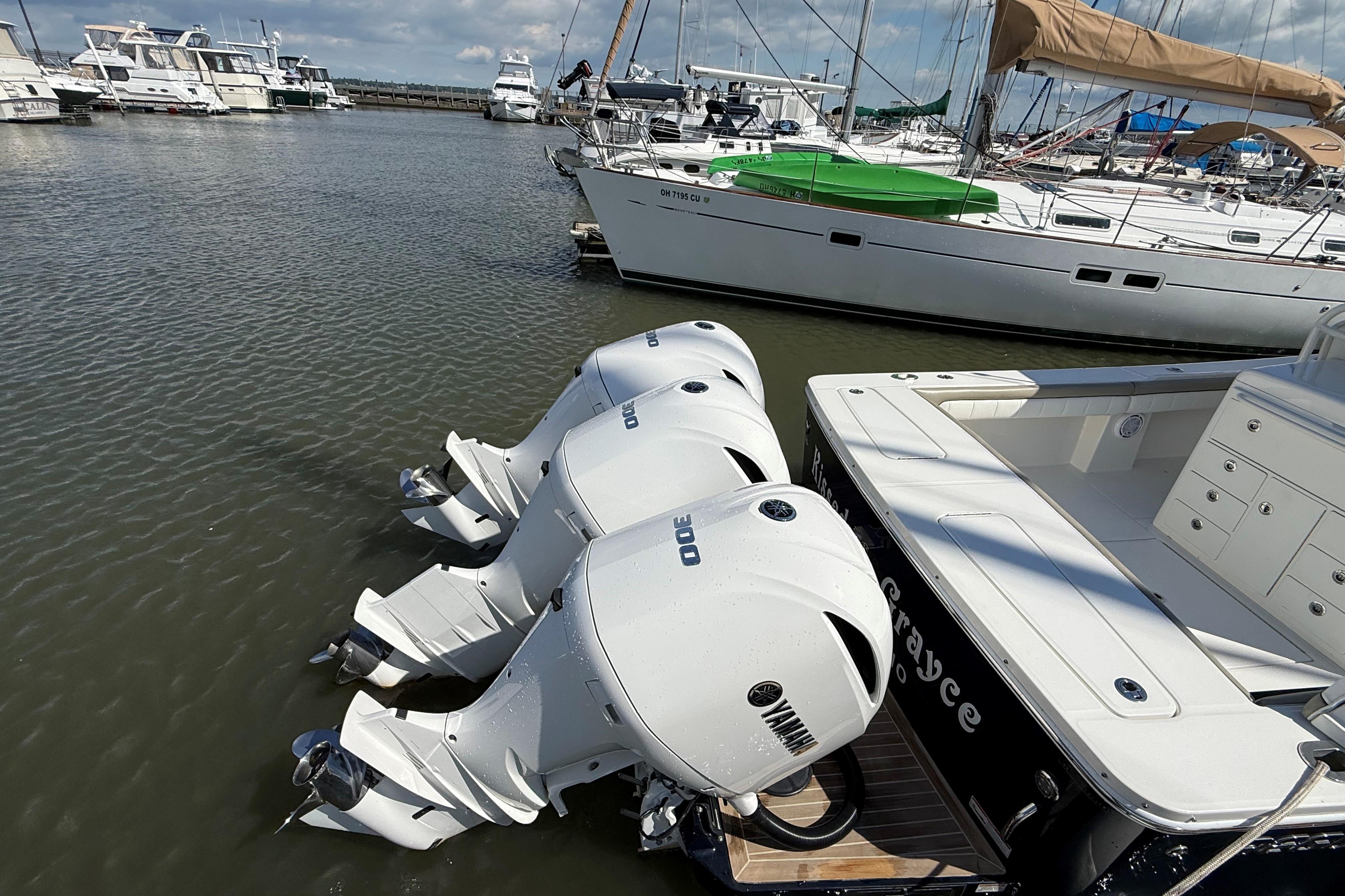 2019 Regulator 34SS boat with triple Yamaha outboard engines docked at a marina.