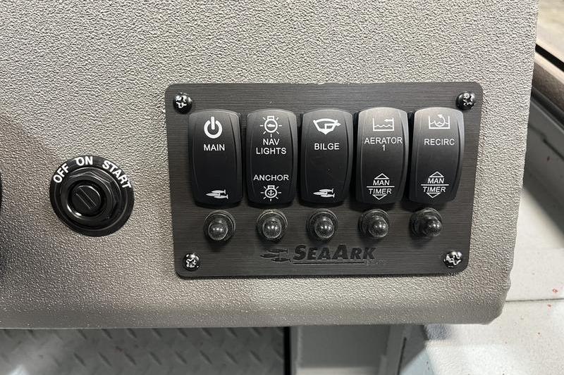 Control panel of 2026 SeaArk Flex 19 Pro boat with various switches.