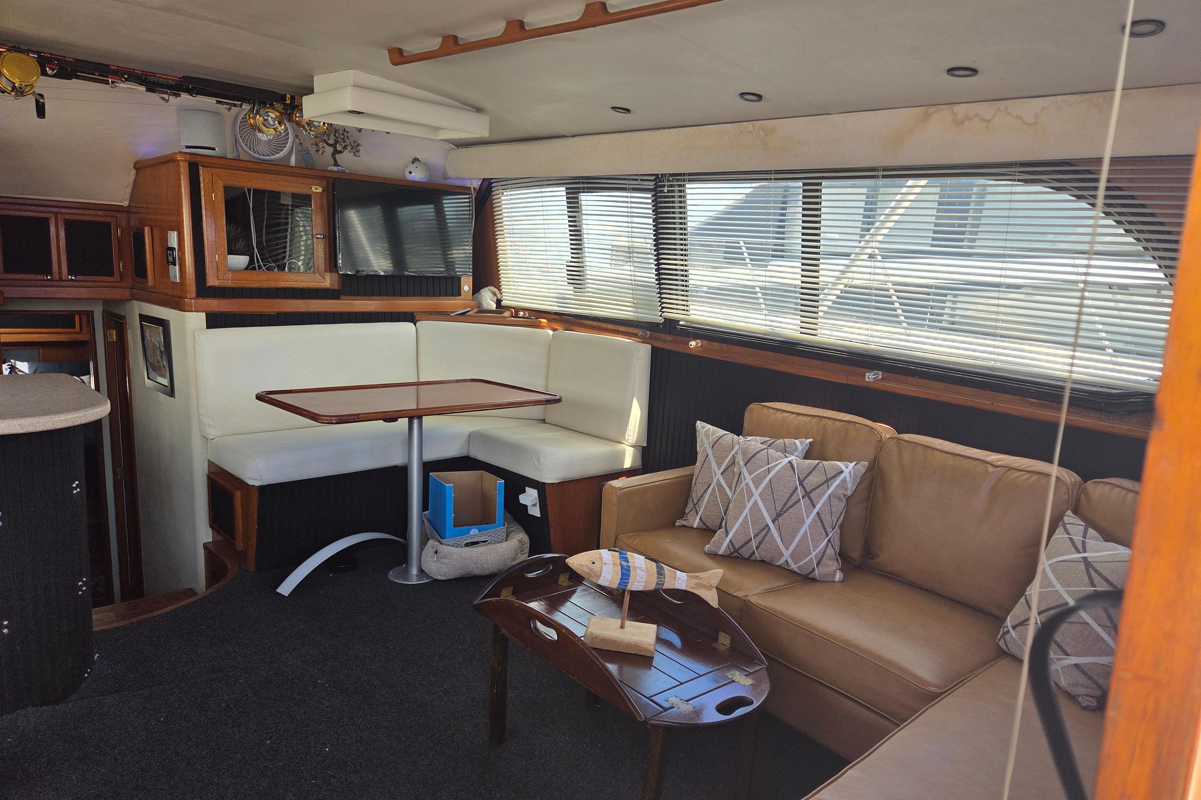 Interior of 1990 Egg Harbor Golden Egg 42 yacht with cozy seating and dining area.