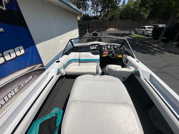 1992 Correct Craft Ski Nautique boat interior with seating and dashboard, parked outdoors.
