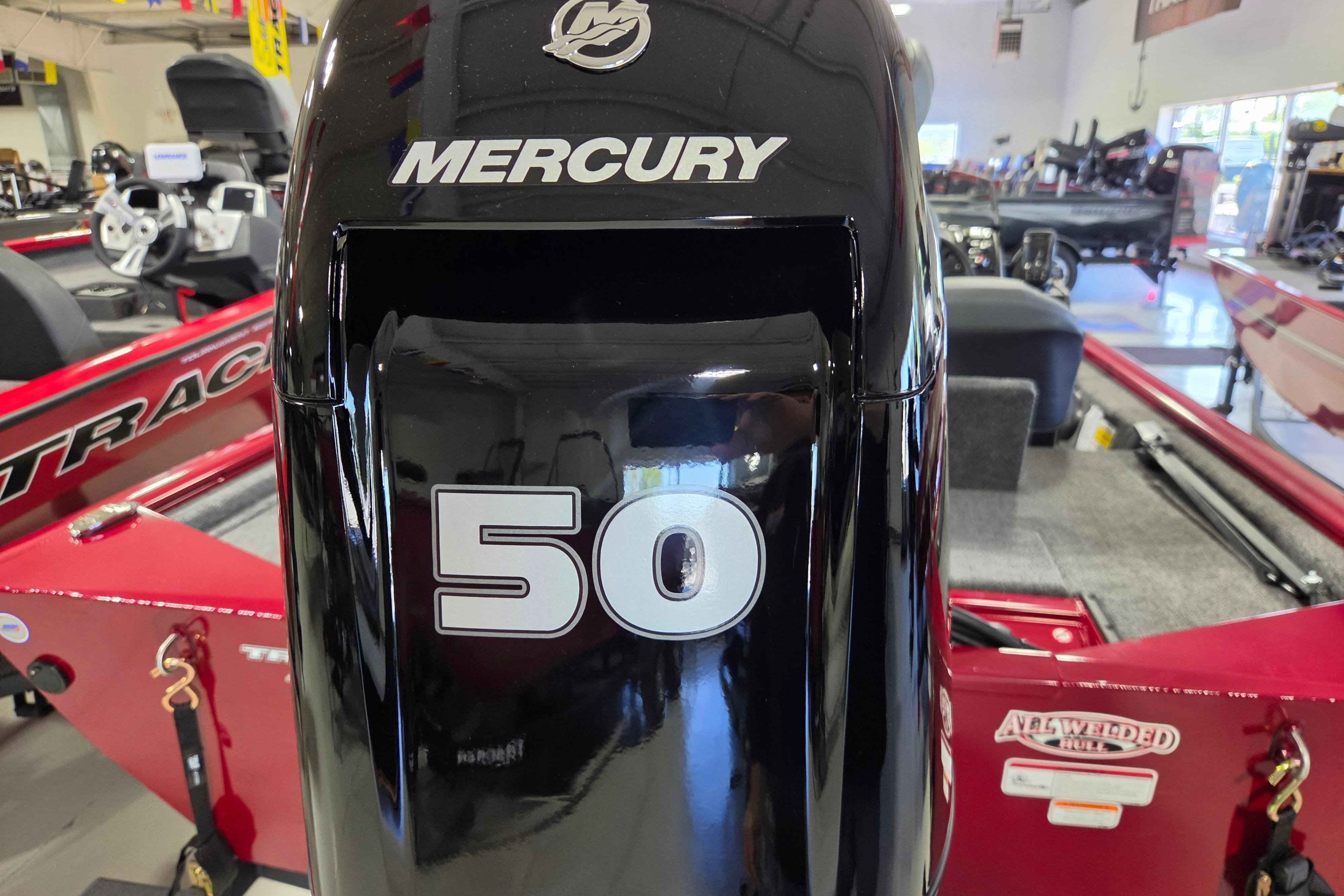 2026 Tracker Pro 170 boat with Mercury 50 horsepower engine in showroom.