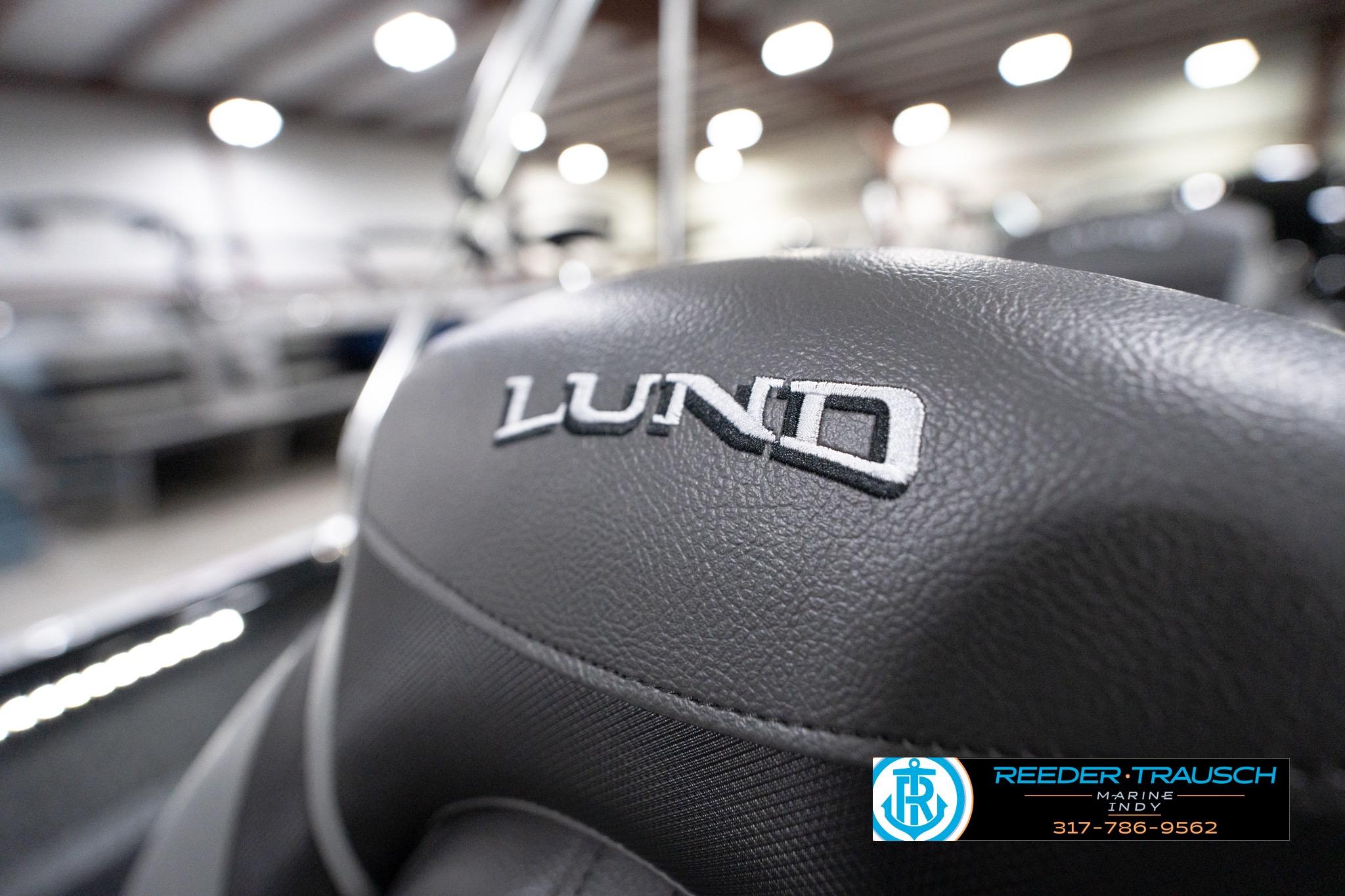 Close-up of 2026 Lund 1800 Explorer Sport seat with logo in showroom.