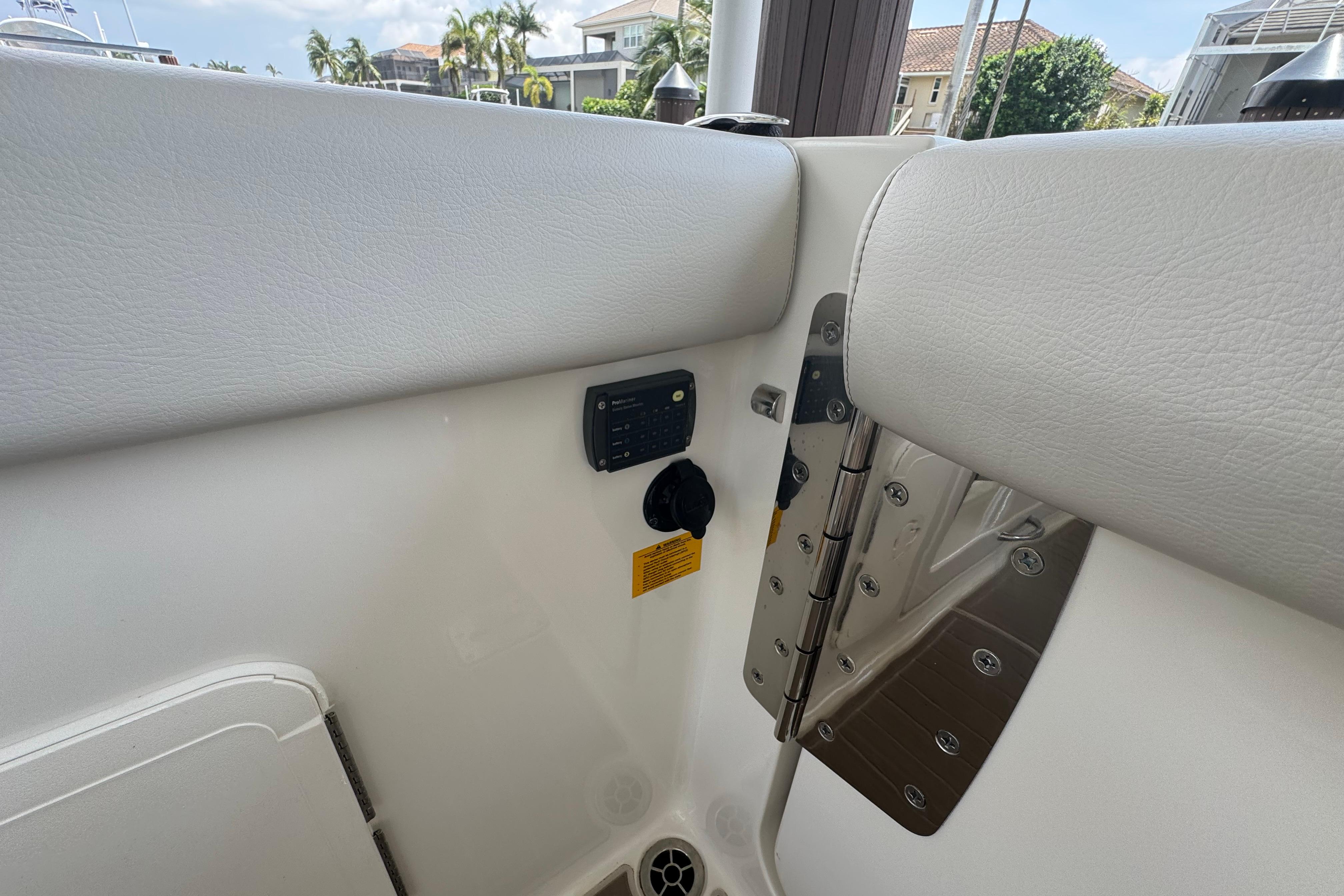 Interior view of 2021 Sailfish 276 DC boat, featuring white seating and control panel.