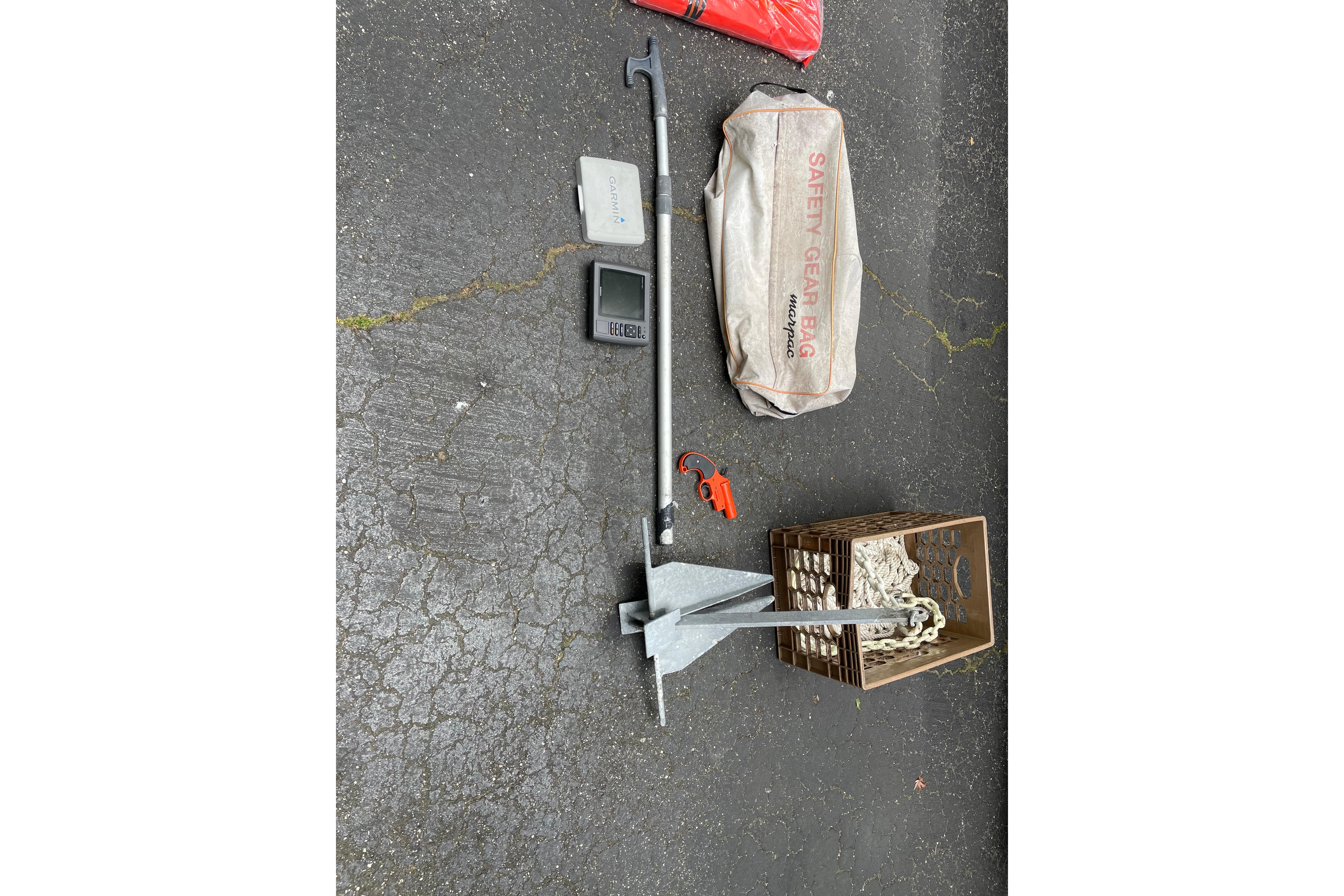 Boat safety gear and anchor for 2008 Sea Hunt Victory 207 on pavement.