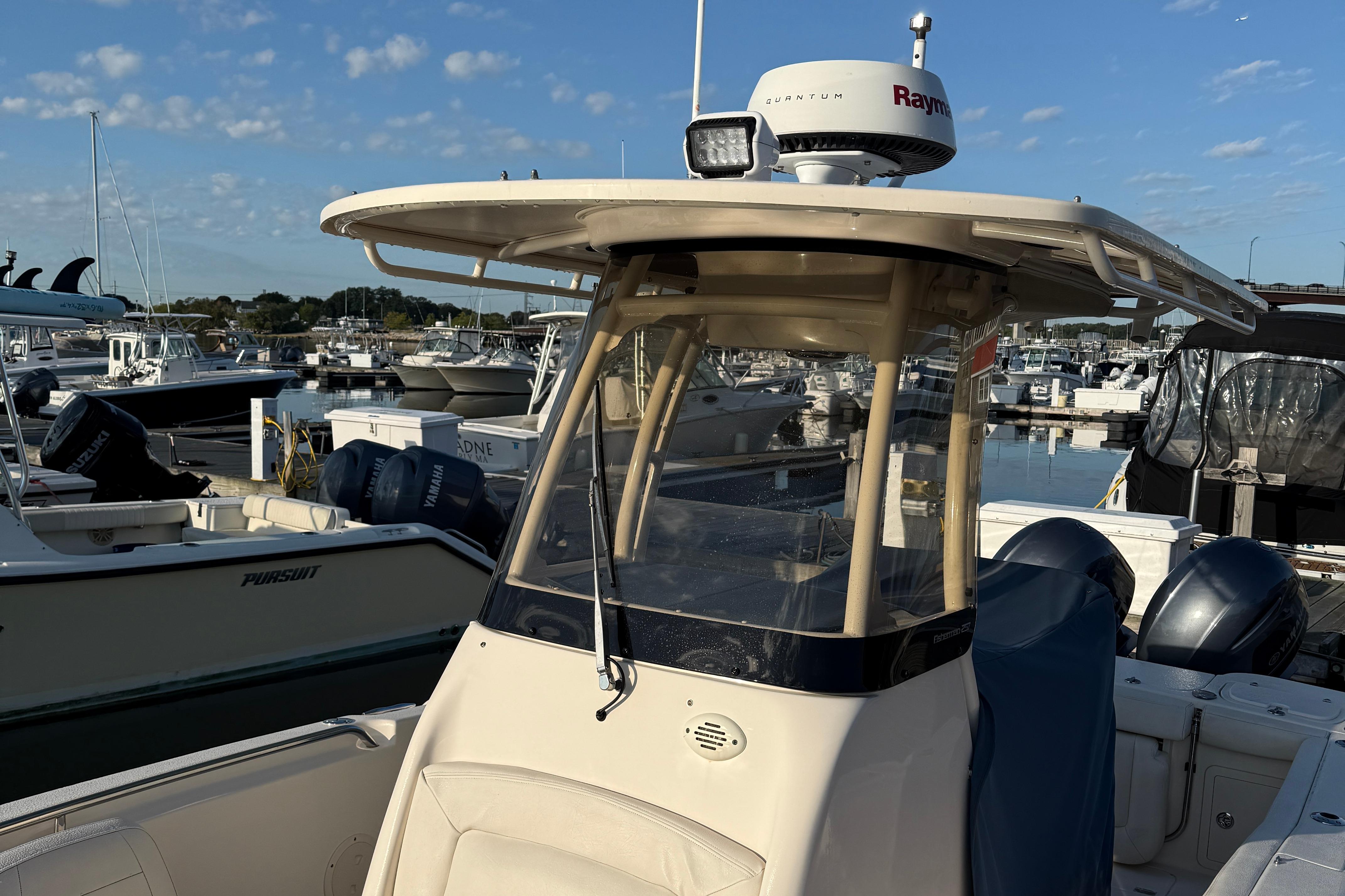 2017 Grady White 257 Fisherman boat docked at marina under clear sky.