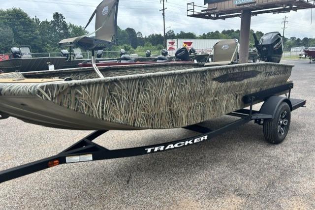 2026 Tracker Grizzly 1650 T Prairie Wings Edition boat on trailer, camo design, outdoor setting.