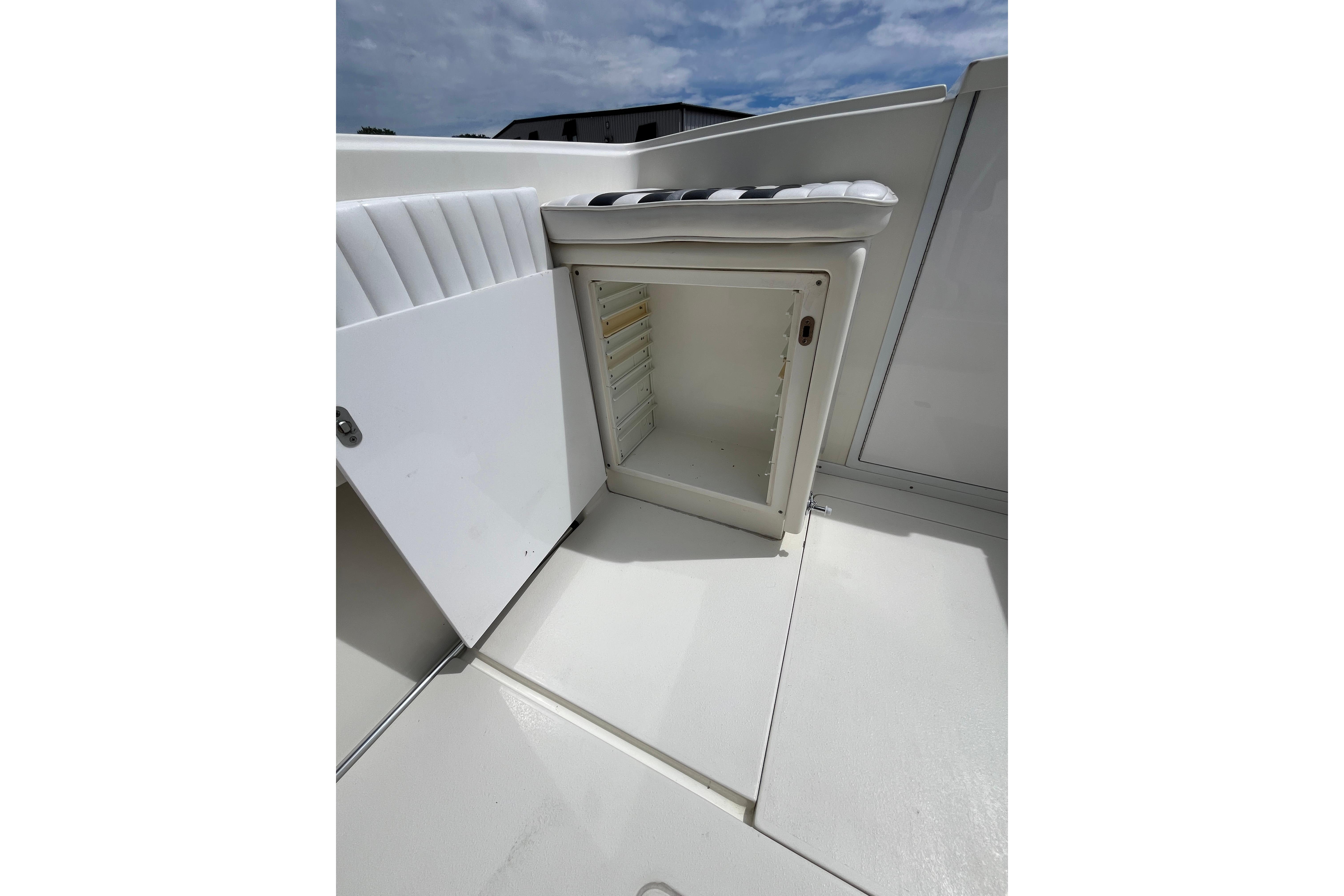 Open storage compartment on 1994 Intrepid 30 Open Cuddy boat deck.