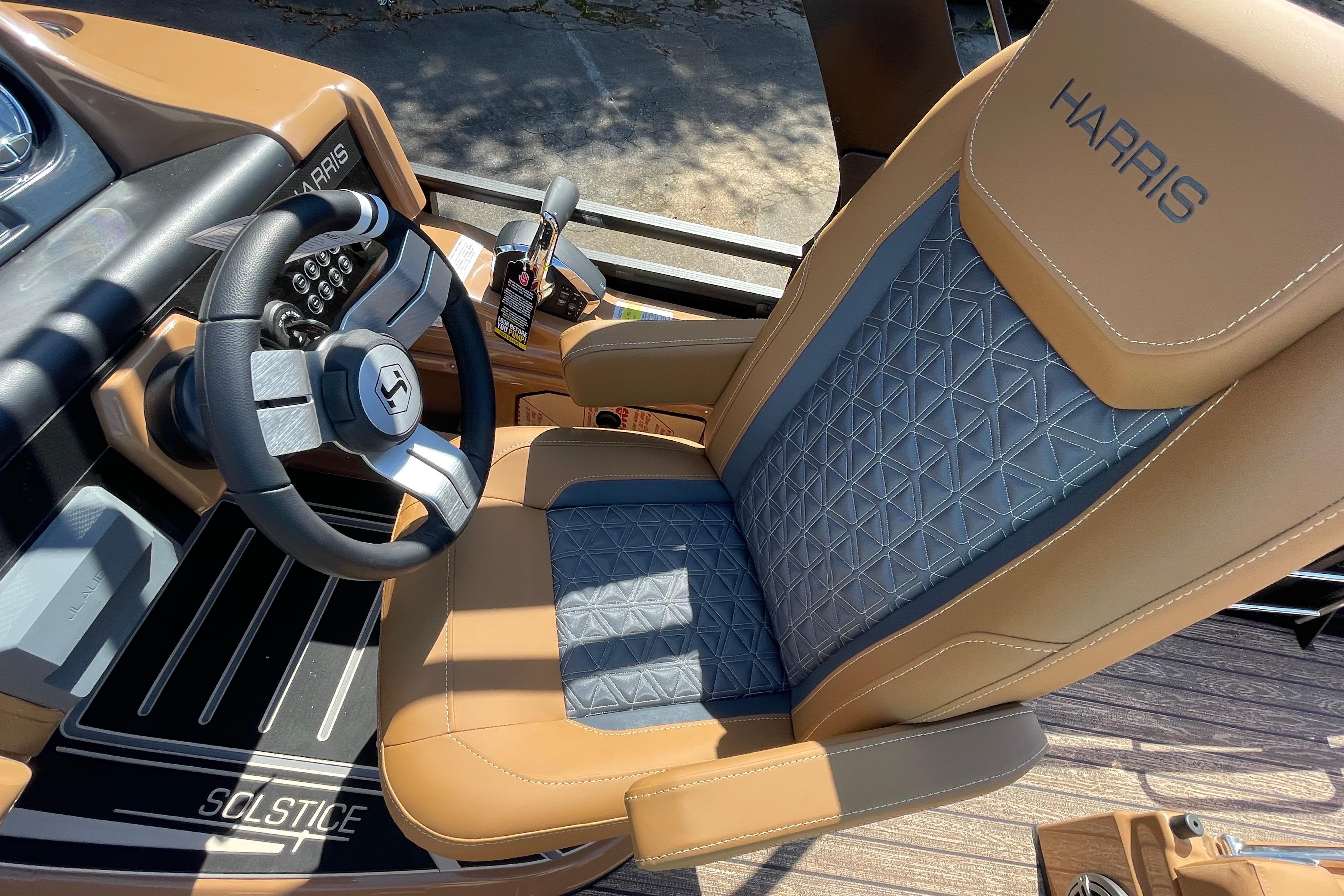 2026 Harris Solstice 250 SLDH boat interior with luxury seating and modern steering wheel.
