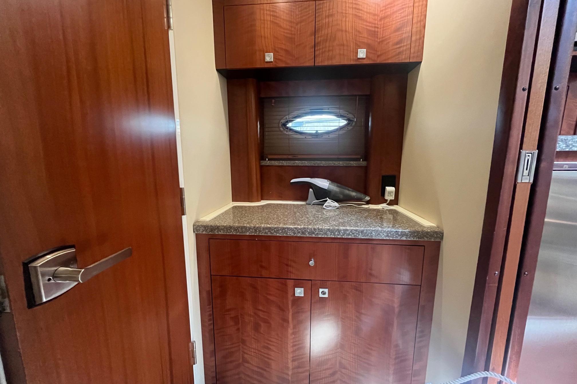 Interior of 2010 Monterey 400 Sport Yacht with wooden cabinetry and countertop.