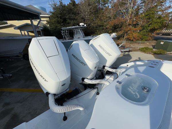 2025 Yellowfin 39 Offshore boat with triple Mercury outboard engines, docked outdoors.