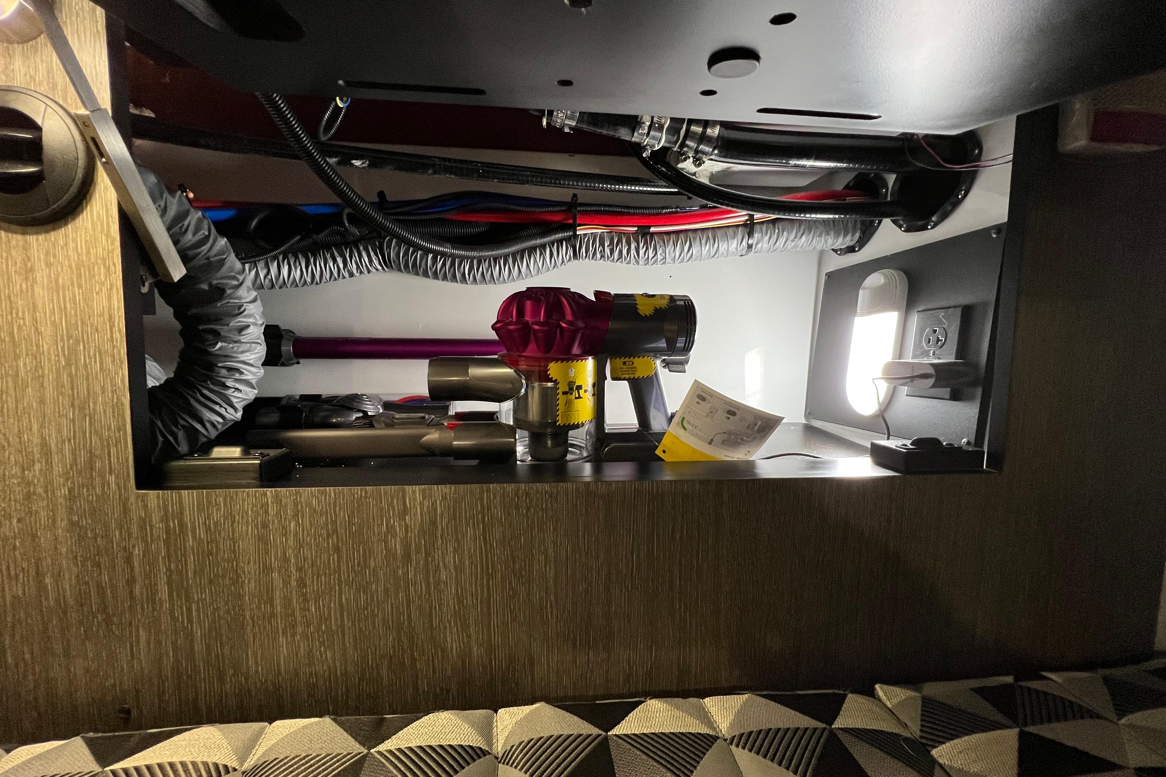 Interior view of a 2023 Monterey 378SS Super Sport boat's storage compartment with equipment and wiring.