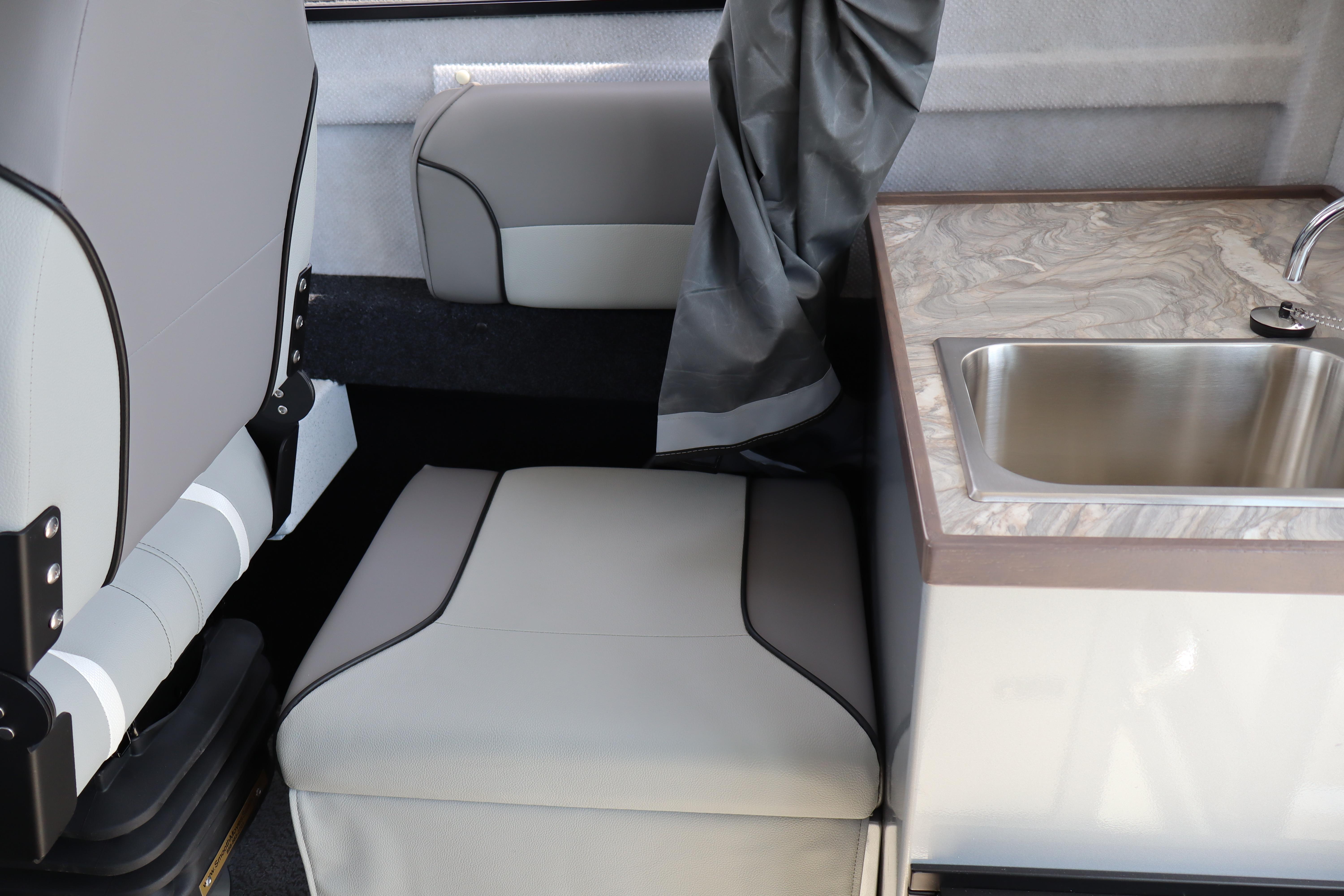 Interior of 2026 KingFisher 25 XAC boat with seating and sink area.