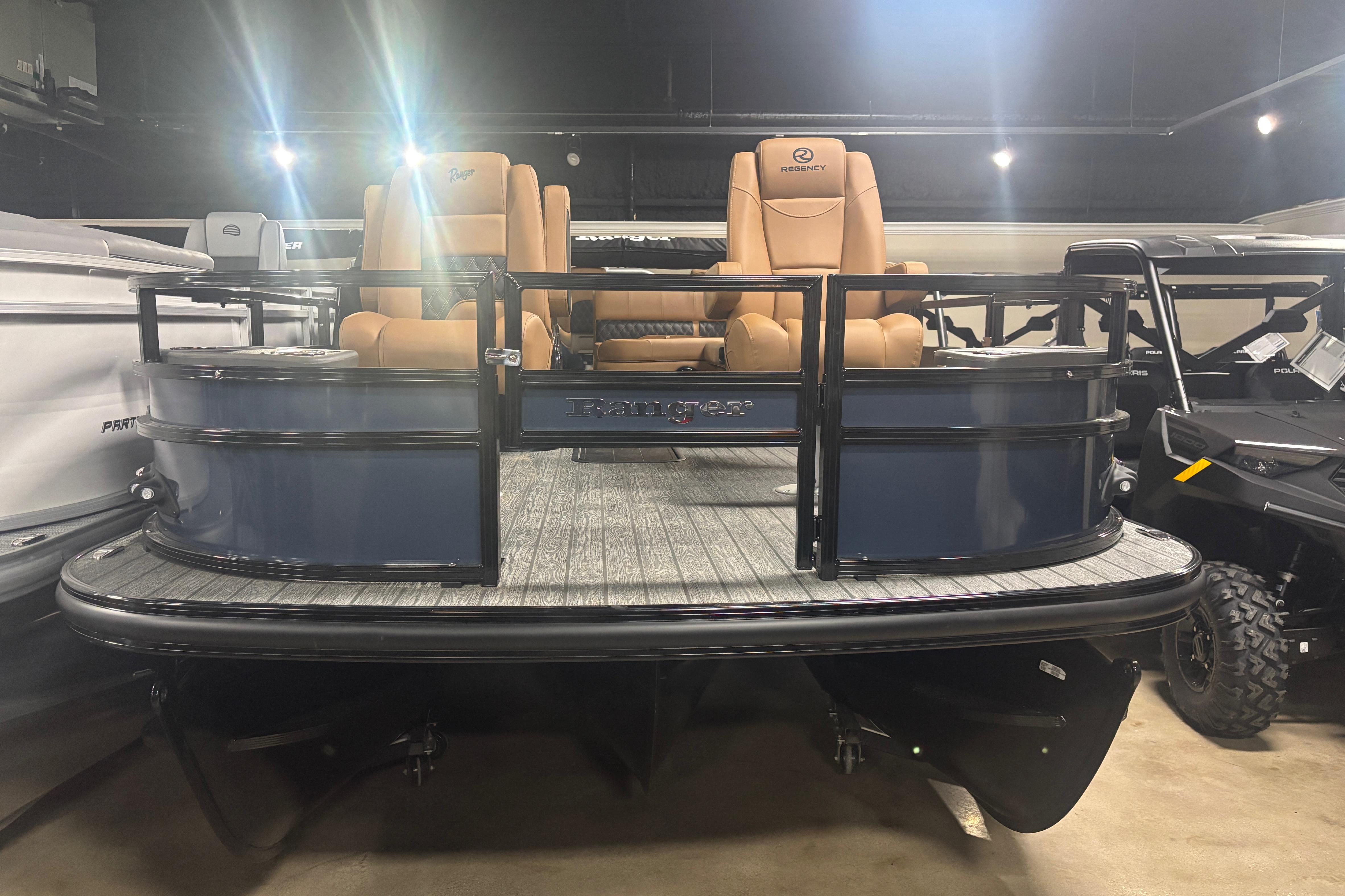 2026 Ranger 223F pontoon boat with tan seats in showroom display.