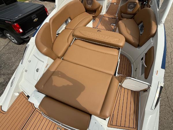 2025 Crownline 290 SS boat interior with tan leather seating and wood accents.