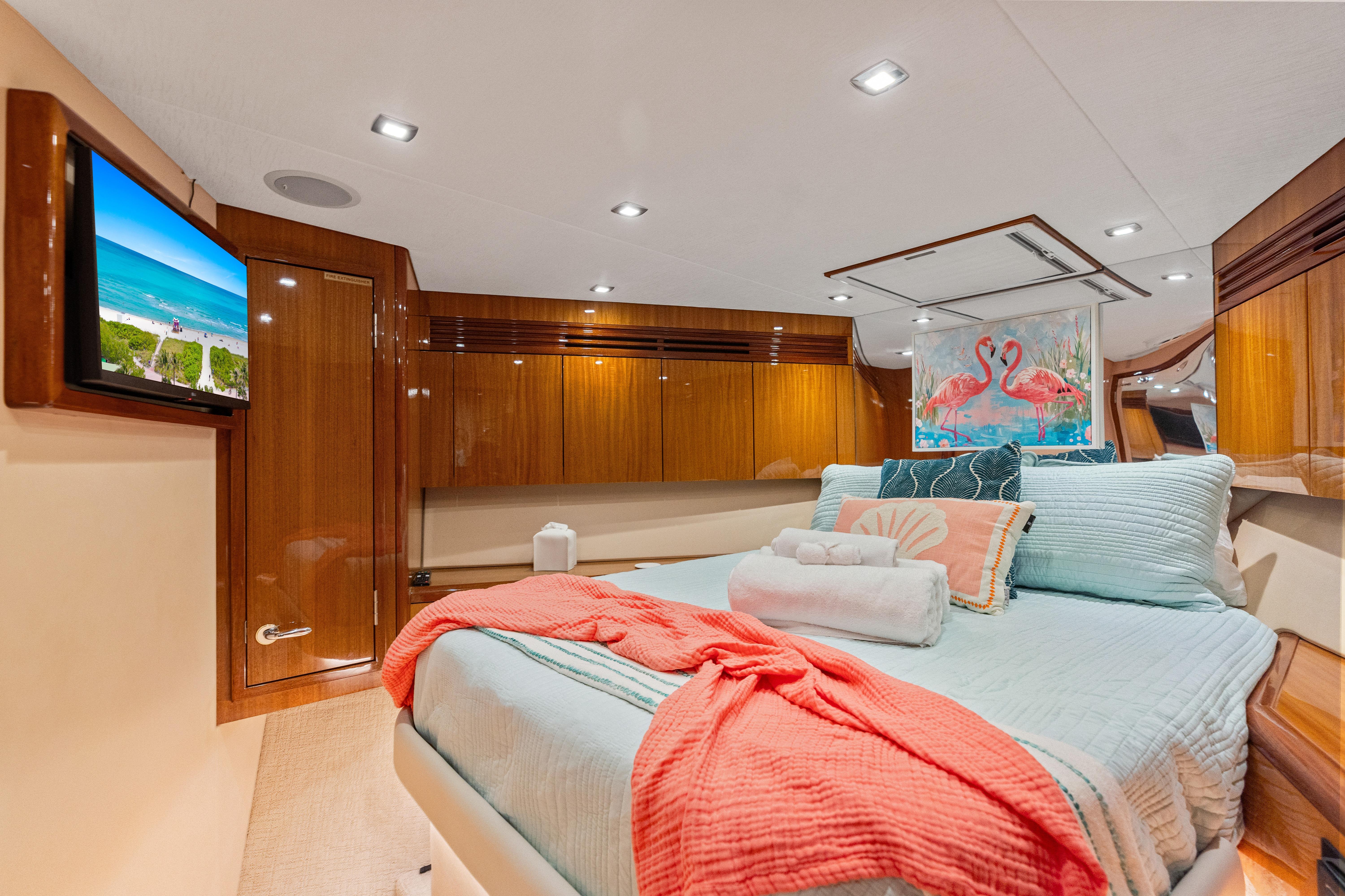 Luxurious bedroom interior of 2008 Hatteras 64 Motor Yacht with elegant decor and modern amenities.