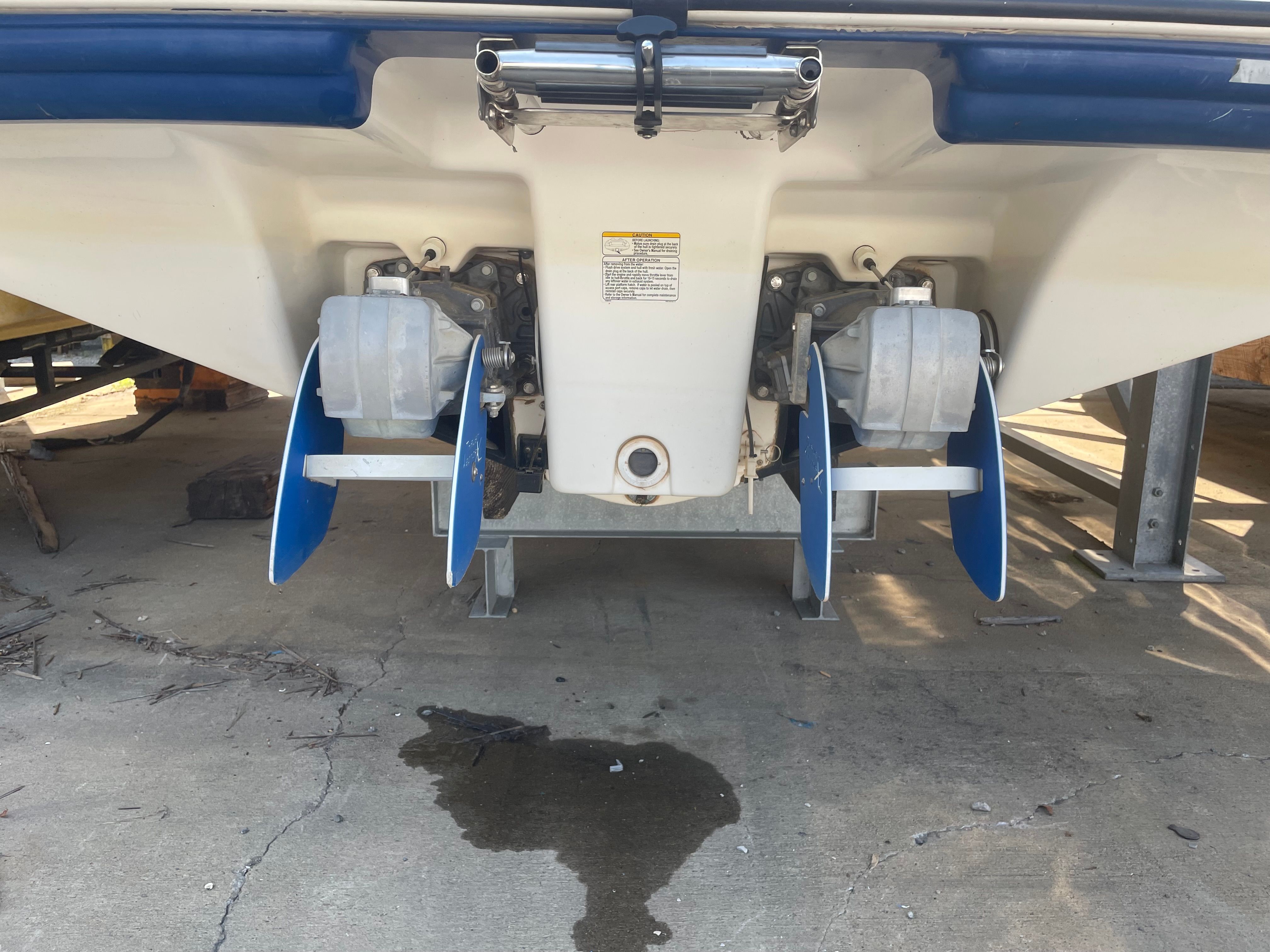 Rear view of a 2006 Yamaha SX230 boat with dual engines and blue fins.